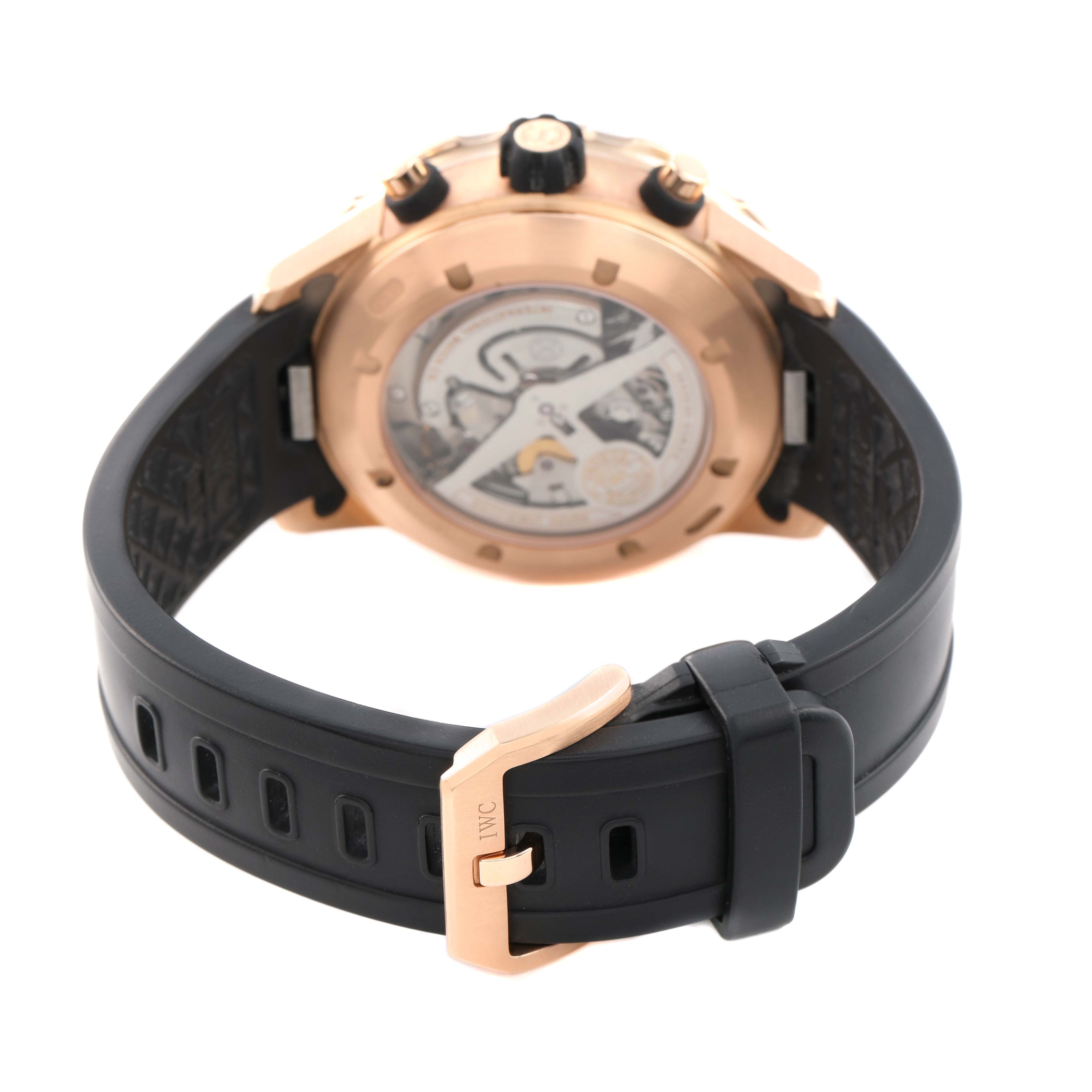 The IWC Aquatimer IW376903 Men's Rose Gold Black Dial watch is shown from the back, highlighting the transparent case back and black strap with a buckle.