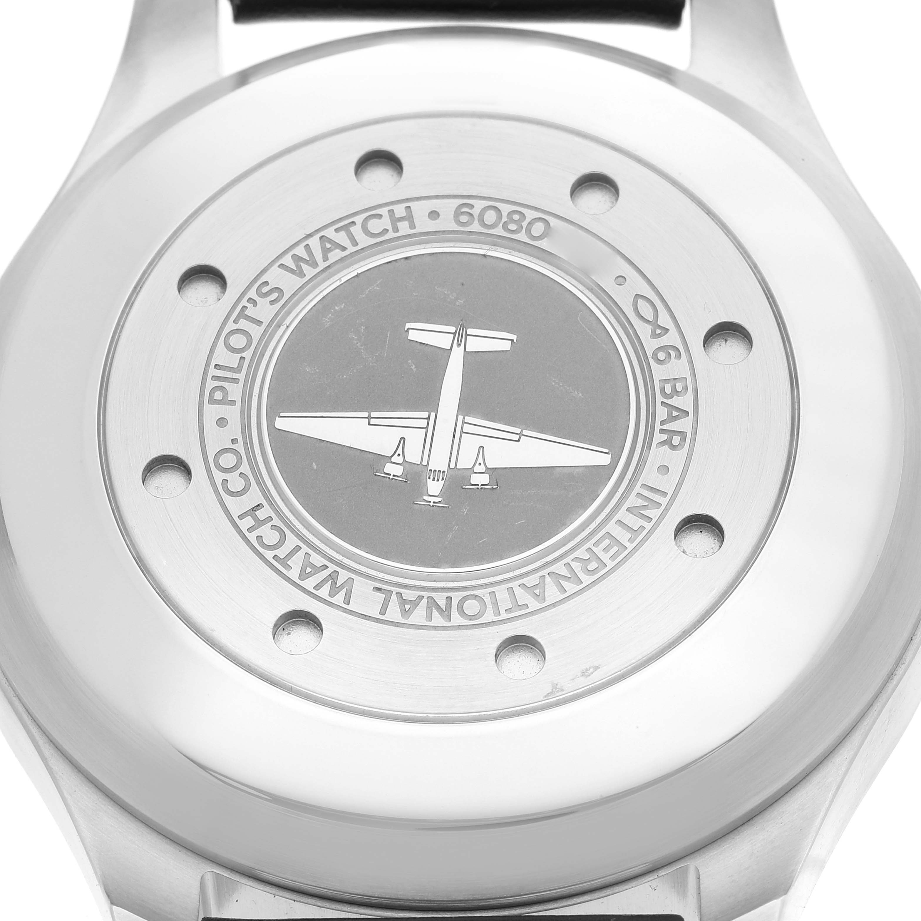 The image shows the back case of an IWC Pilot IW500912 Men's Stainless Steel Black Dial IW500912 Men's Stainless Steel Black Dial's Watch model 6080, featuring an airplane engraving.
