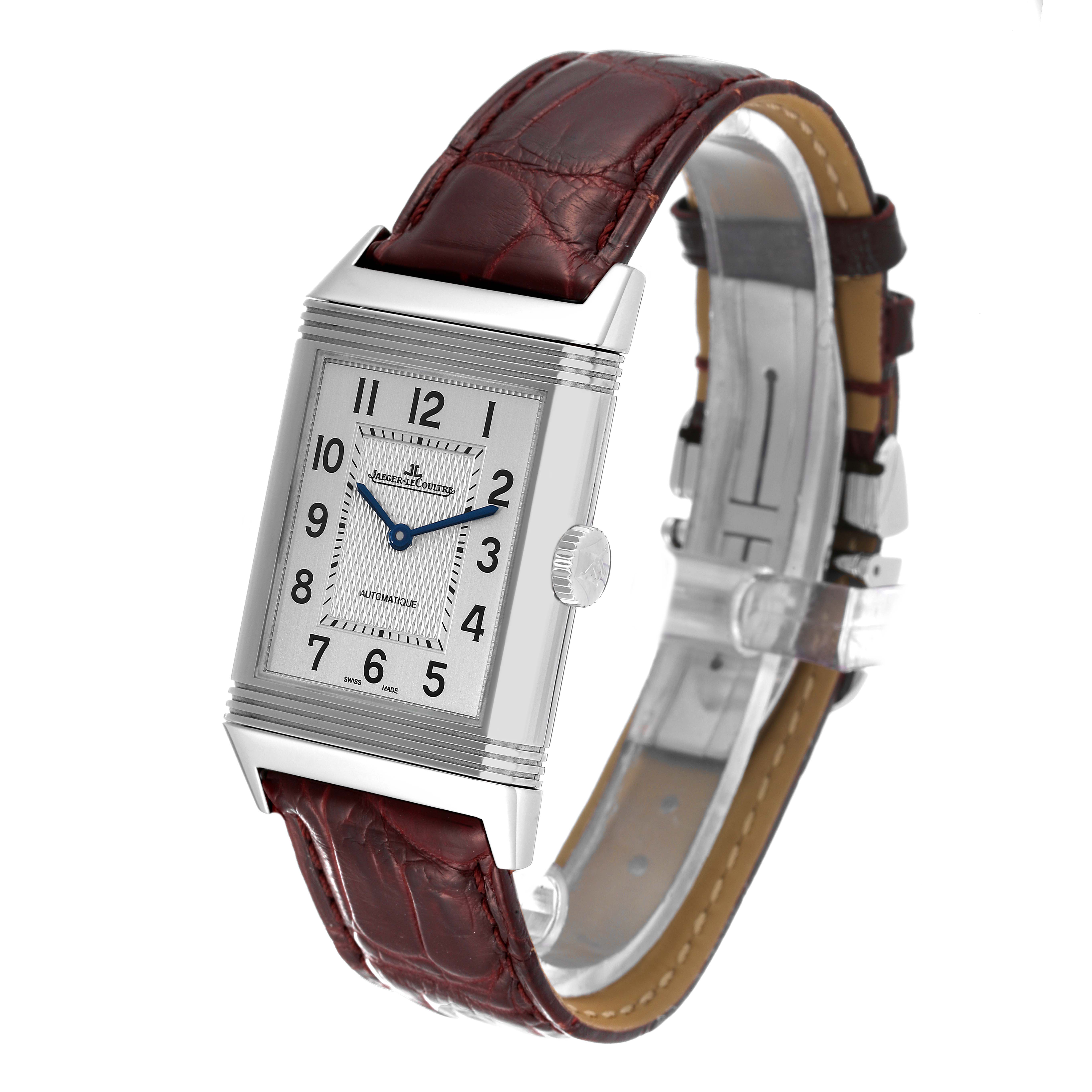 The Jaeger LeCoultre Reverso Q3828420 Men's Stainless Steel Silver Dial Q3828420 Men's Stainless Steel Silver Dial watch is shown at an angle highlighting its rectangular face, silver case, and brown leather strap.