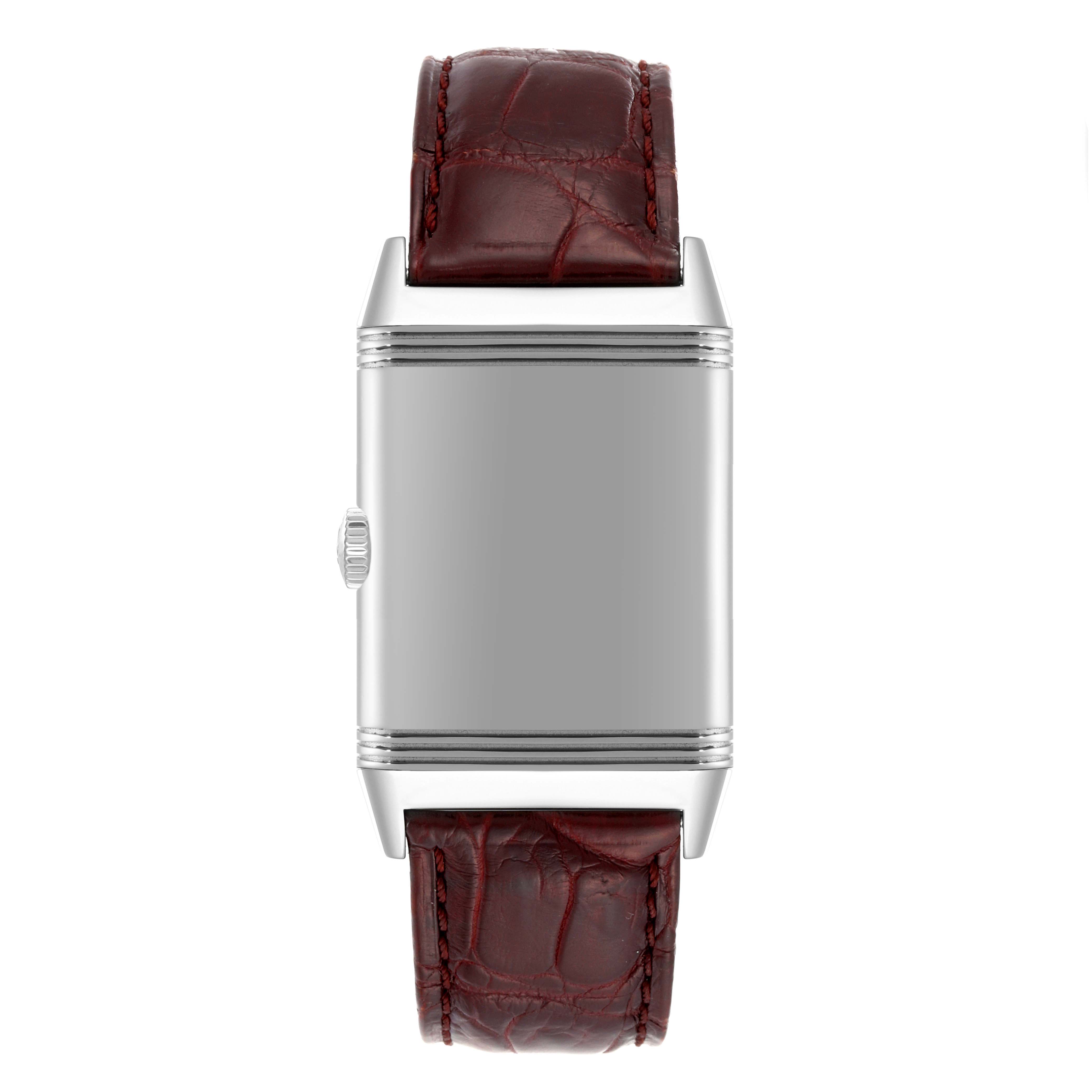 The image shows a front view of the Jaeger LeCoultre Reverso Q3828420 Men's Stainless Steel Silver Dial Q3828420 Men's Stainless Steel Silver Dial watch with a red leather strap and a plain rectangular face.