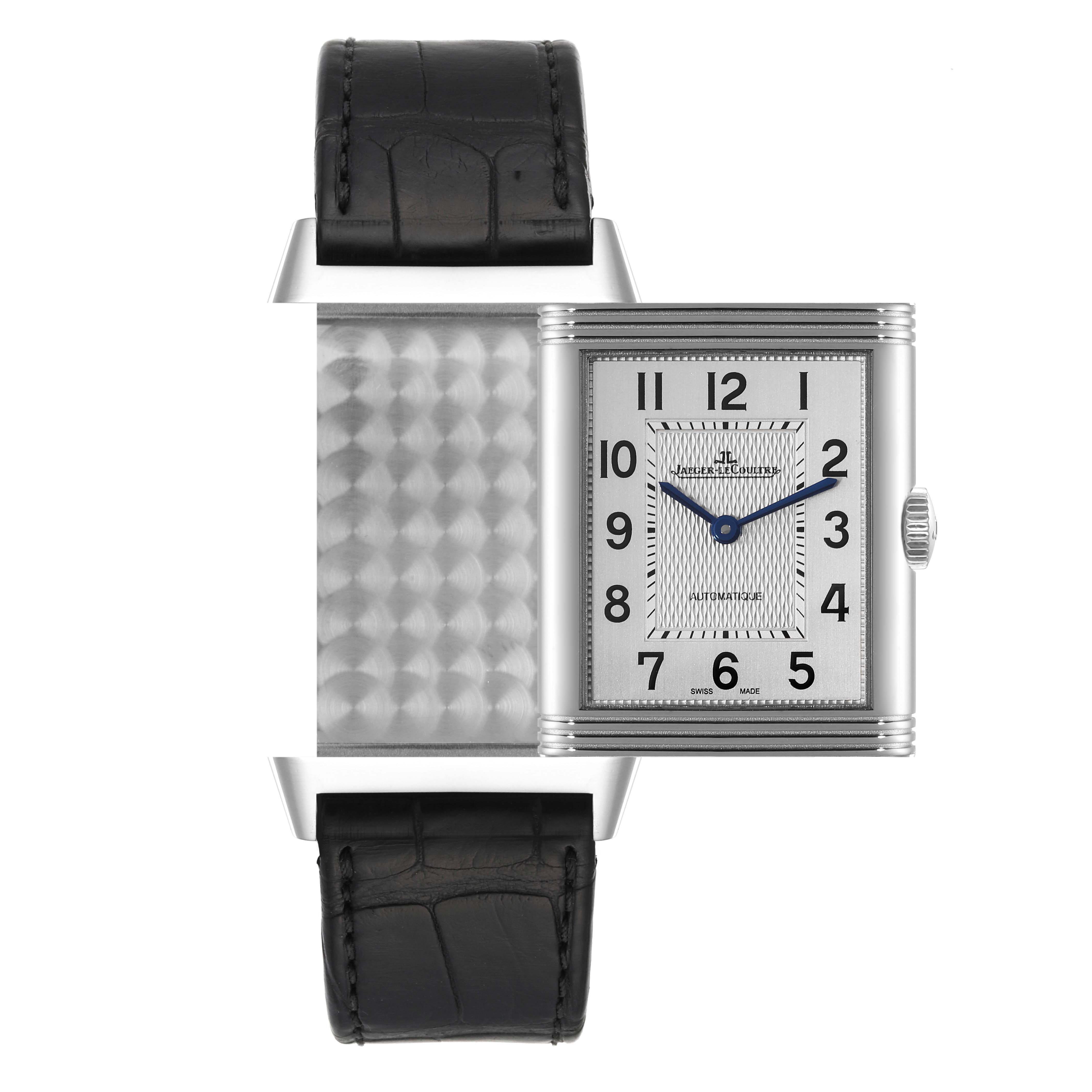 The Jaeger-LeCoultre Reverso watch is shown from the front, displaying its rectangular dial and partially flipped case showcasing the reverse side.