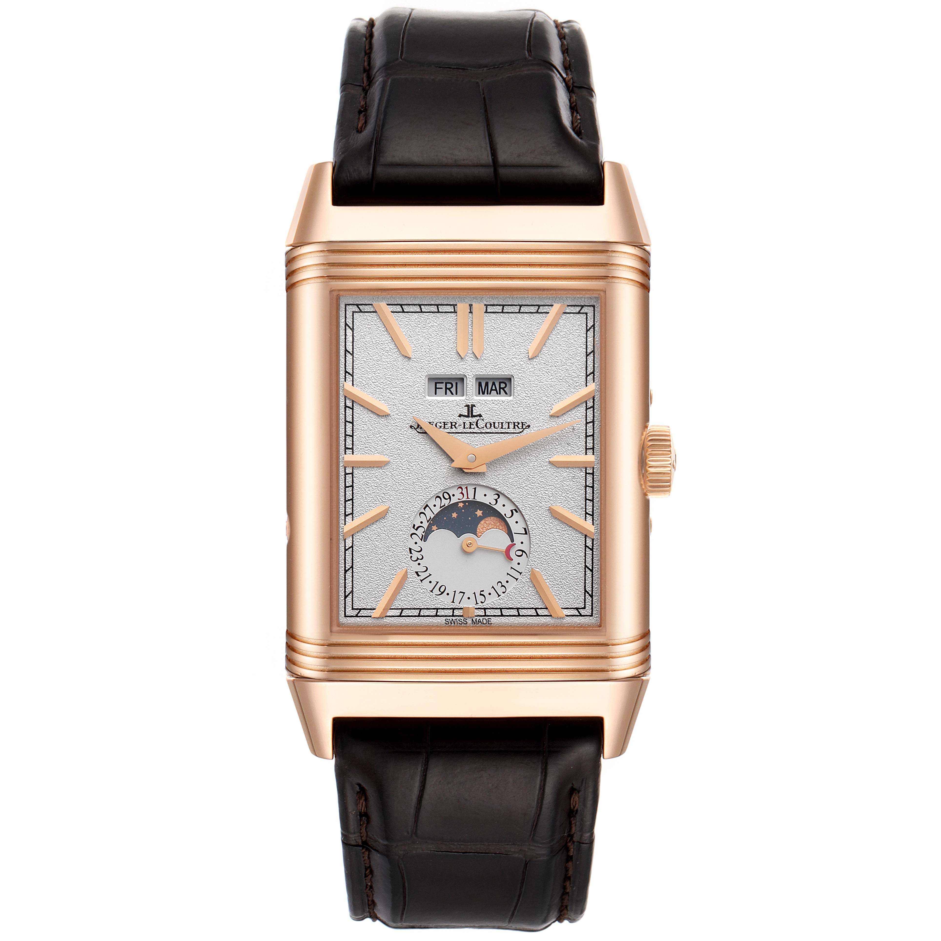 The image shows a front view of a Jaeger-LeCoultre Reverso watch, with a rectangular face, brown leather strap, and day-date complications.