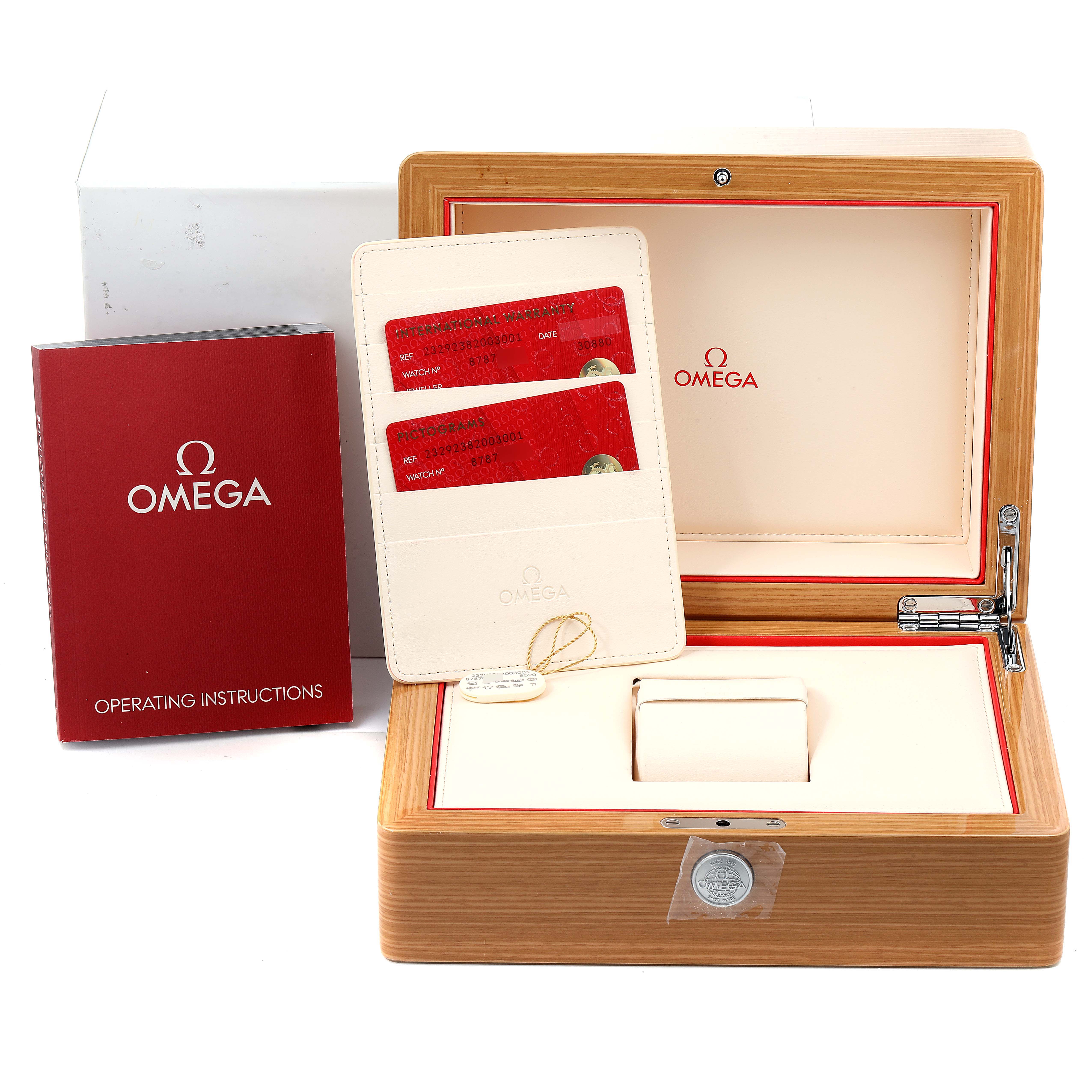 The image shows the packaging, instruction manual, warranty cards, and accessories for the Omega Planet Ocean 232.92.38.20.03.001 Men's Titanium Blue Dial 232.92.38.20.03.001 Men's Titanium Blue Dial watch.