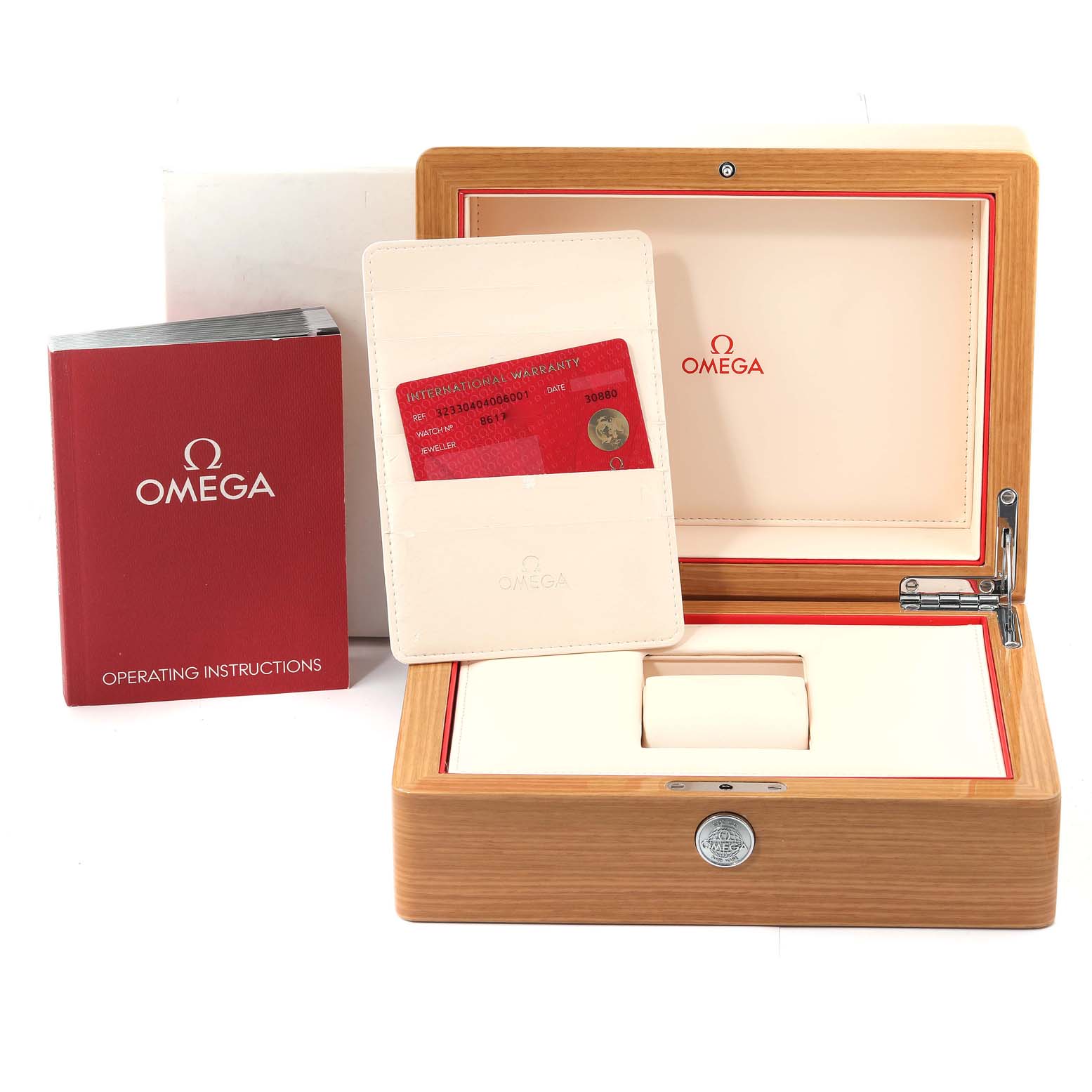 The image shows the Omega Speedmaster 323.30.40.40.06.001 Men's Stainless Steel Grey Dial 323.30.40.40.06.001 Men's Stainless Steel Grey Dial watch box, warranty card, and operating instructions from a front angle.