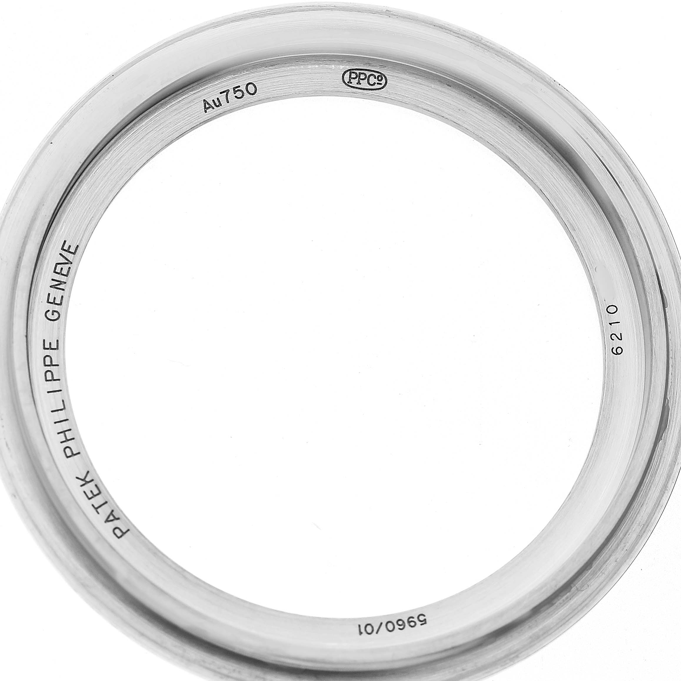 The image shows a close-up of the bezel from a Patek Philippe Complications 5960 Men's White Gold Blue Dial watch with visible engravings.