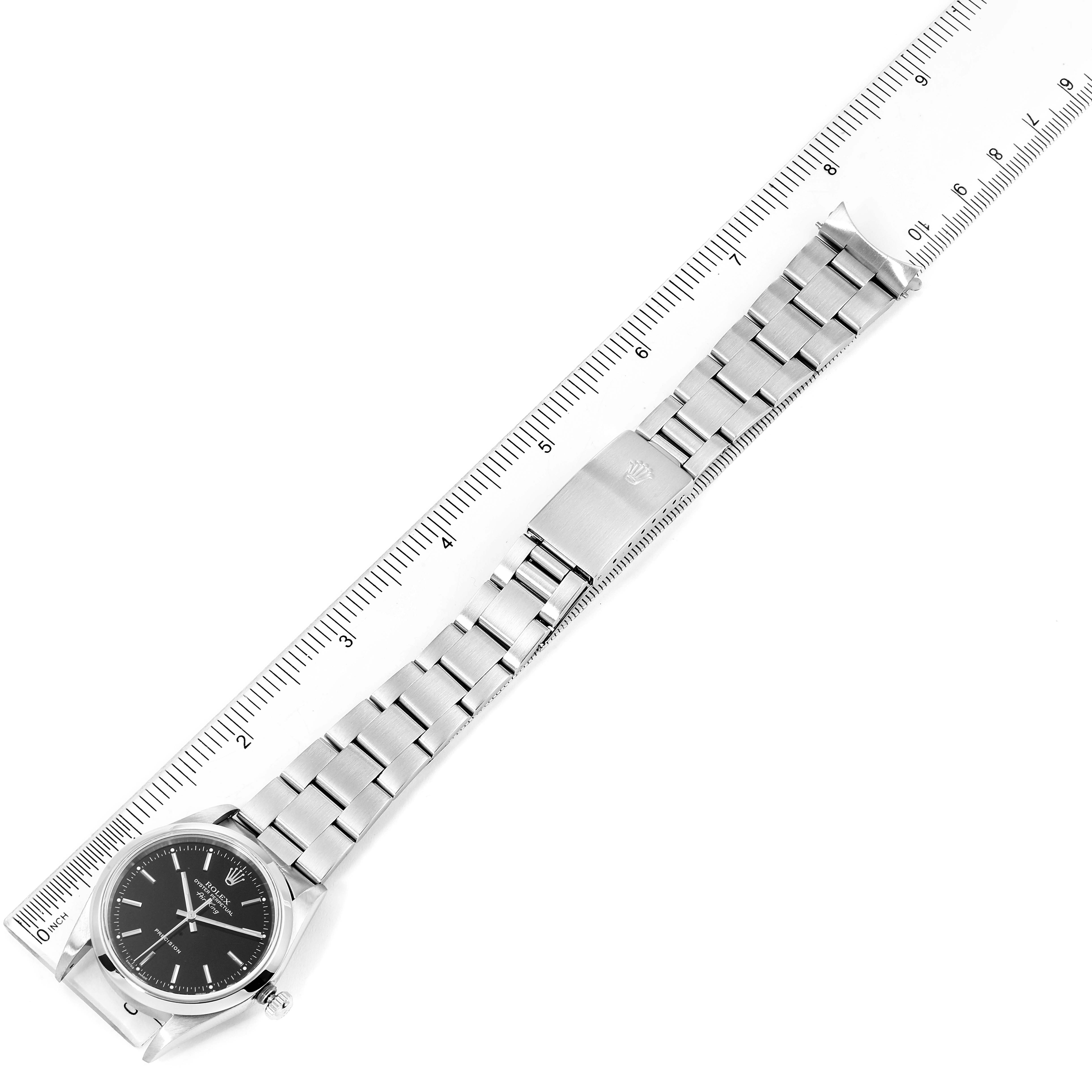 The image shows a top-down view of a Rolex Air-King 14000 Men's Stainless Steel Black Dial 14000 Men's Stainless Steel Black Dial watch, highlighting its full band and dial alongside a ruler for scale.