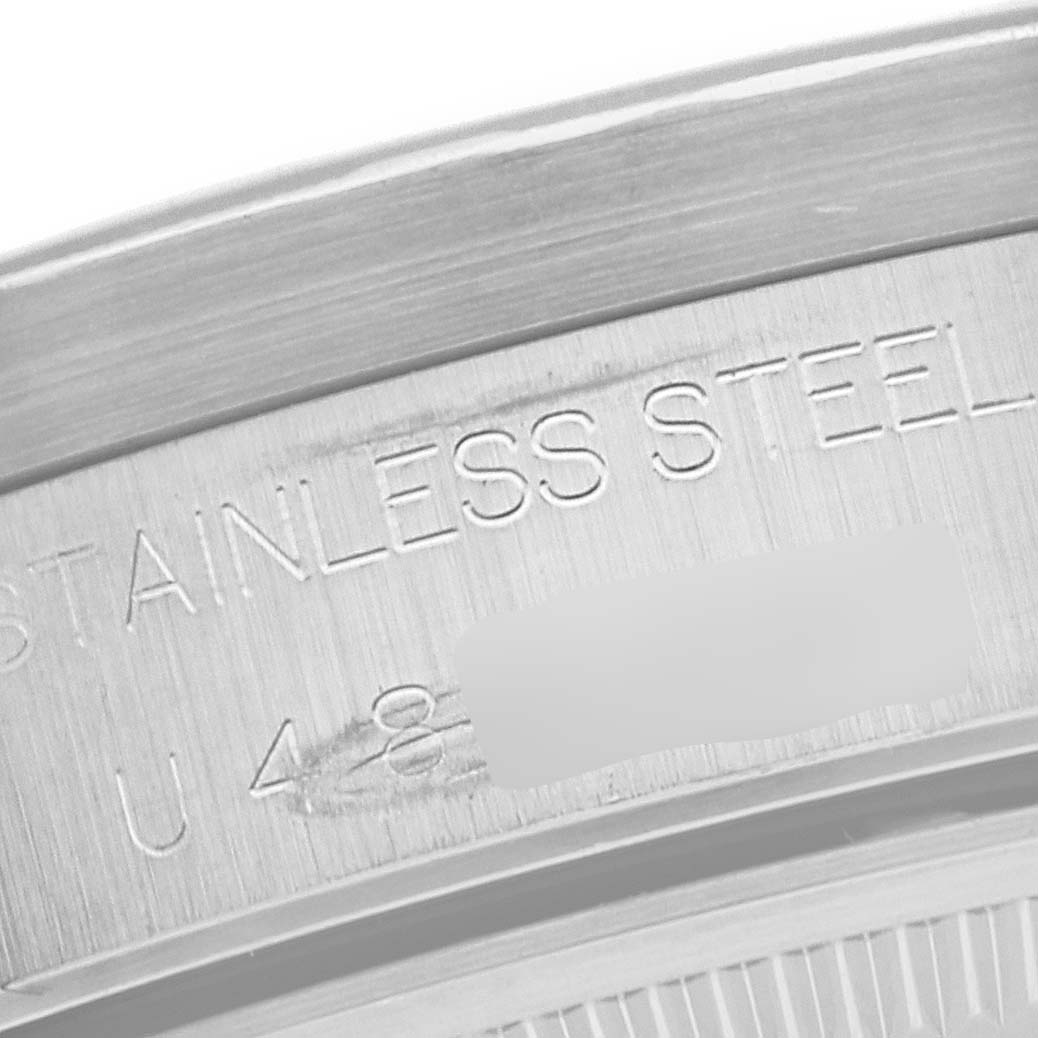This image shows a close-up of the case back of a Rolex Air-King 14010 Men's Stainless Steel Pink Dial 14010 Men's Stainless Steel Pink Dial, highlighting the engraved "STAINLESS STEEL" text.