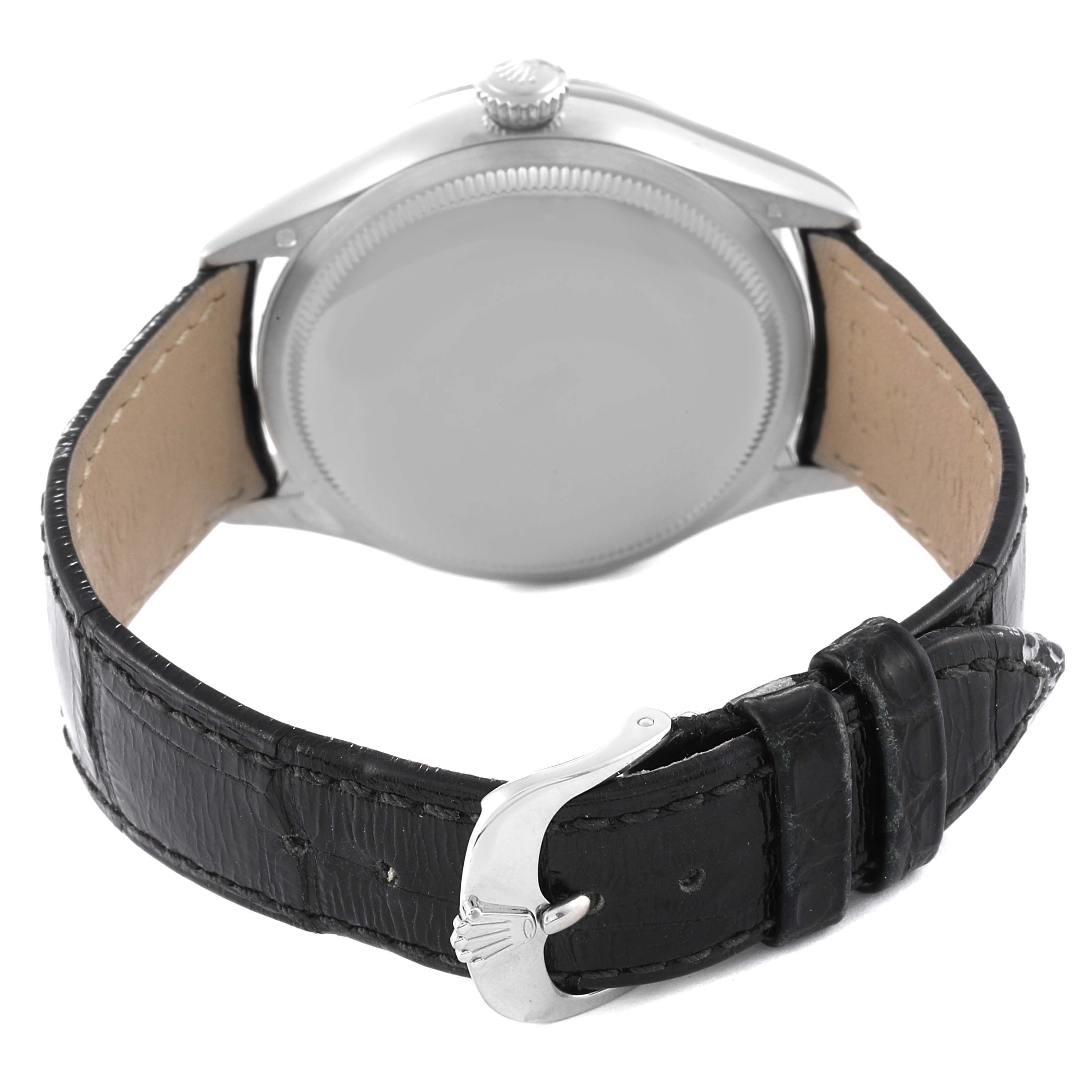 The image shows the back view of a Rolex Cellini 50519 Men
s White Gold Silver Dial 50519 Men
s White Gold Silver Dial watch, highlighting its case back, crown, and black leather strap with the buckle.
