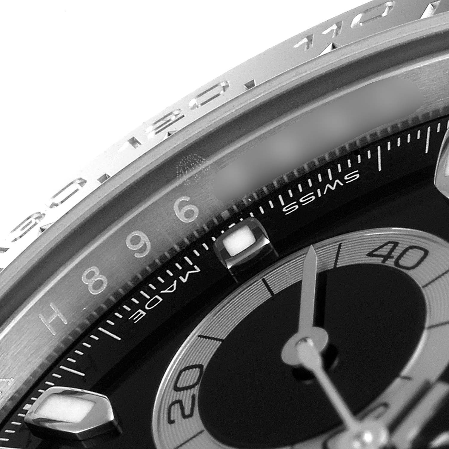 This close-up image of the Rolex Daytona 116500 Men's Stainless Steel Black Dial 116500 Men's Stainless Steel Black Dial watch shows the bezel, dial, and part of the sub-dial from an angle.