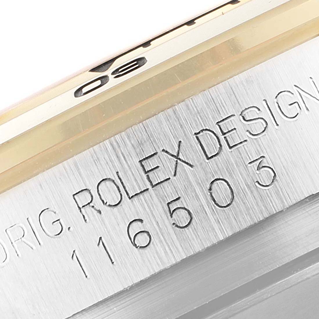 The image shows a close-up of the case edge of a Rolex Daytona 116503 Men's Steel and Gold (two tone) Black Dial 116503 Men's Steel and Gold (two tone) Black Dial watch, featuring the model number 116503 and "ORIG. ROLEX DESIGN" engraving.
