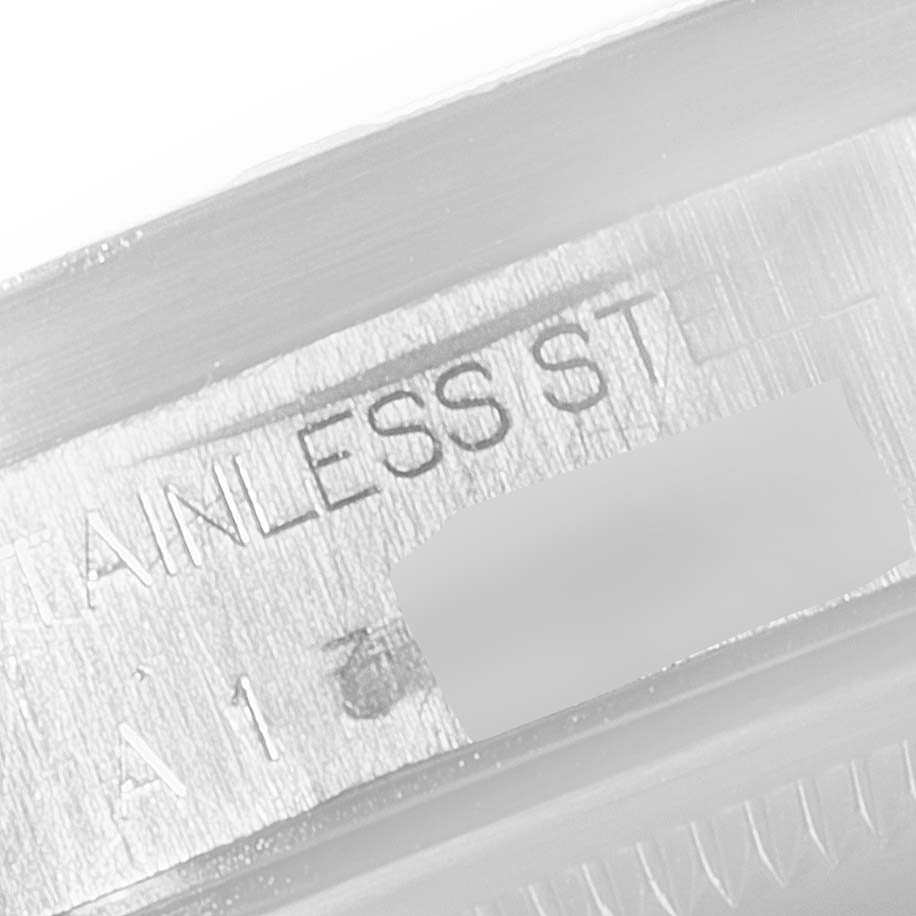 This image shows a close-up of the engraved "STAINLESS STEEL" marking on the inner case or bezel of a Rolex Date 15210 Men's Stainless Steel Black Dial 15210 Men's Stainless Steel Black Dial watch.