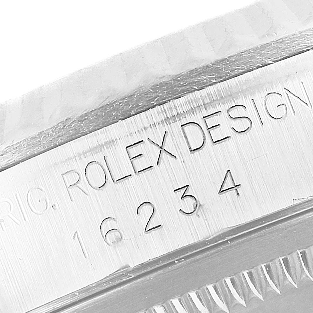 This is a close-up view of the serial number engraving on the casing of a Rolex Datejust 16234 Men
s Stainless Steel Blue Dial 16234 Men
s Stainless Steel Blue Dial watch.
