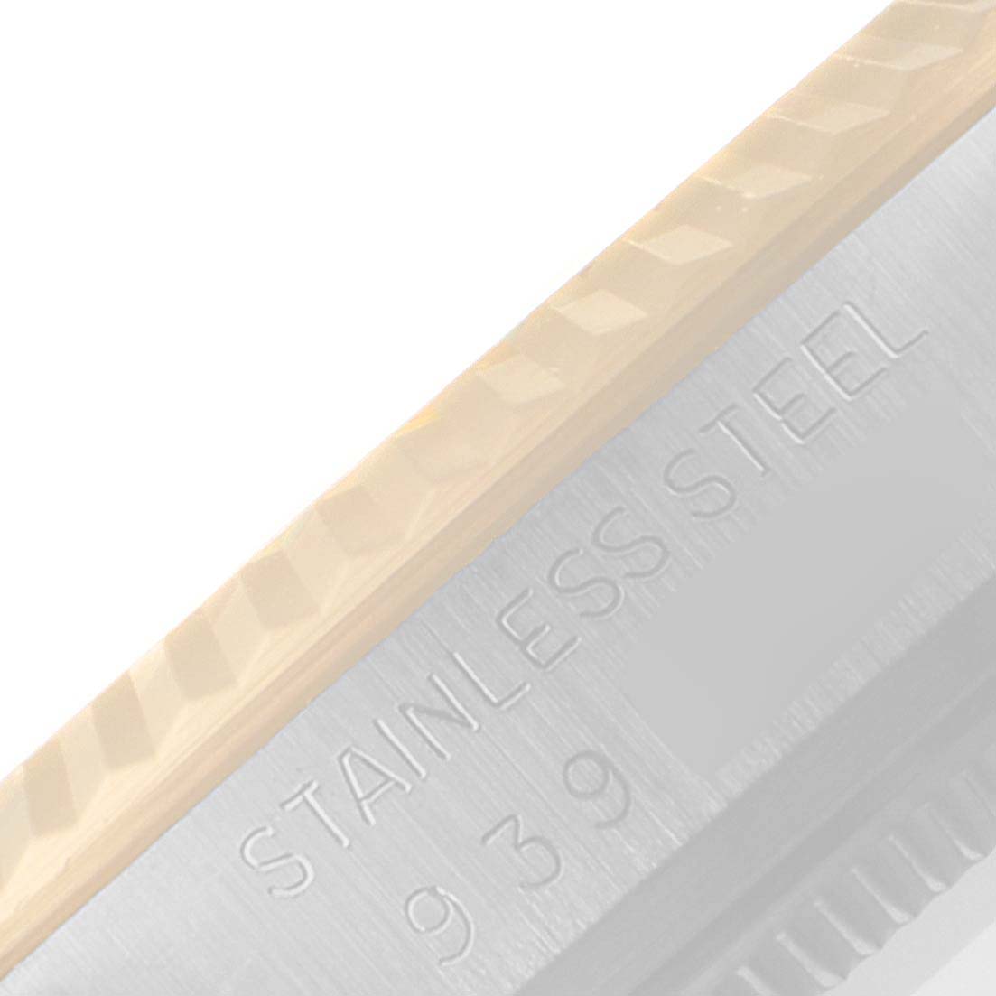 This image shows a close-up of the fluted bezel and the "STAINLESS STEEL" engraving on a Rolex Datejust 16013 Men
s Steel and Gold (two tone) Champagne Dial 16013 Men
s Steel and Gold (two tone) Champagne Dial watch.