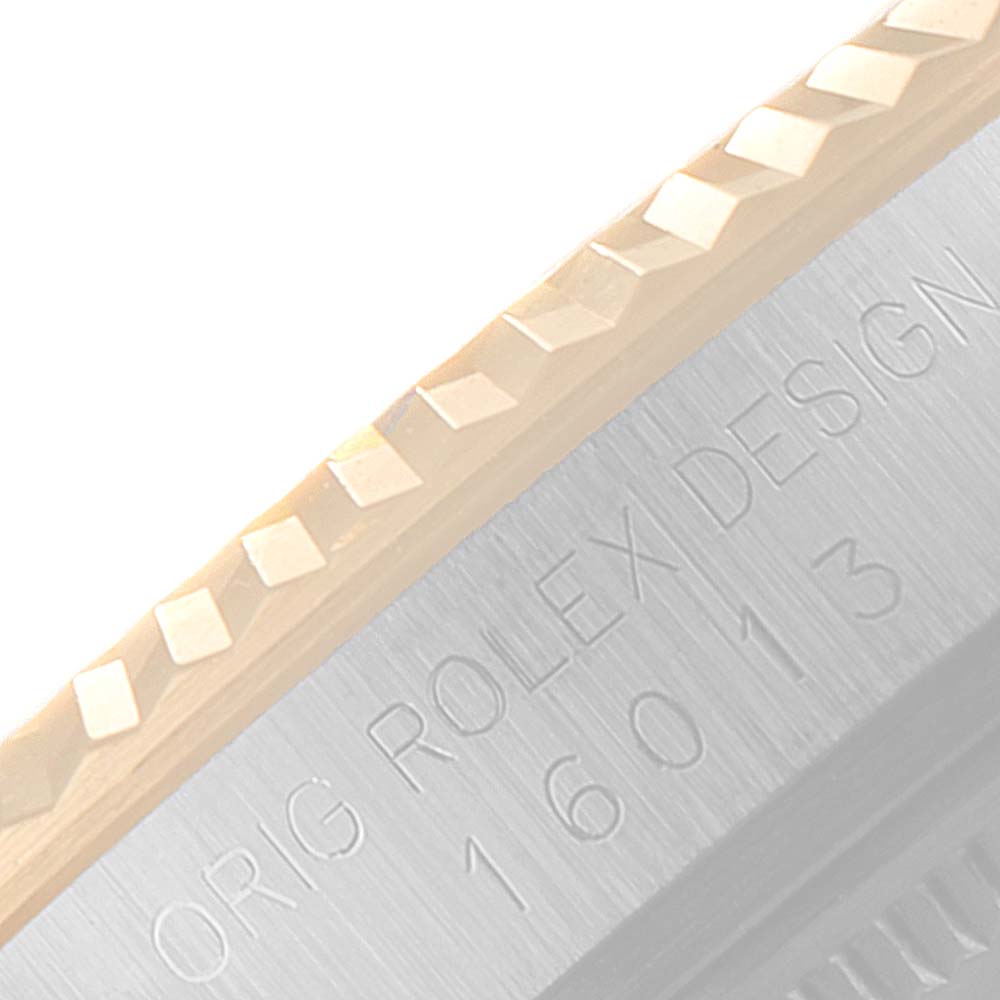 The image shows a close-up of the fluted bezel and engraved side of a Rolex Datejust 16013 Men
s Steel and Gold (two tone) Champagne Dial 16013 Men
s Steel and Gold (two tone) Champagne Dial watch.