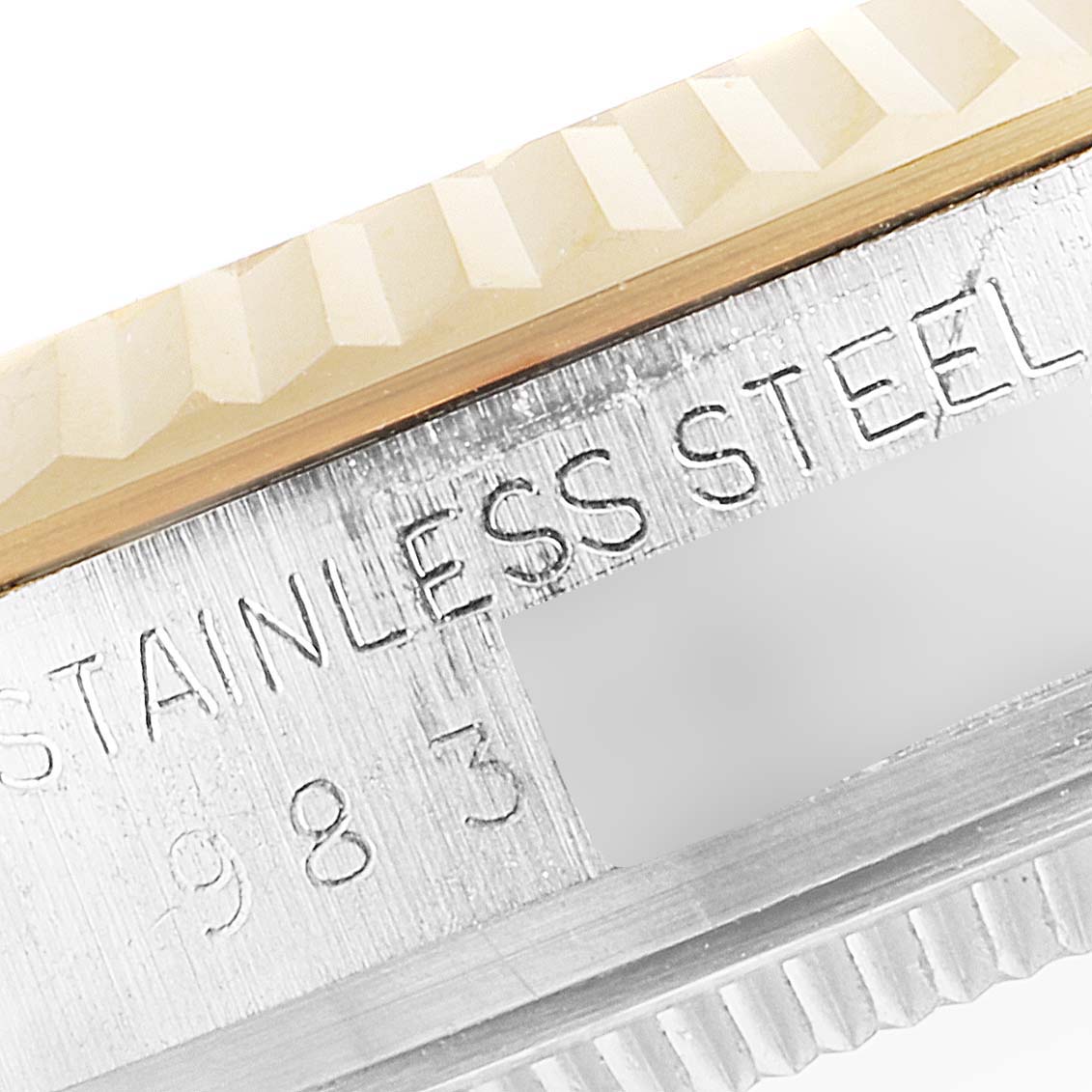 The image shows a close-up of the case edge and part of the bezel of the Vintage Collection model by Rolex, highlighting "STAINLESS STEEL."