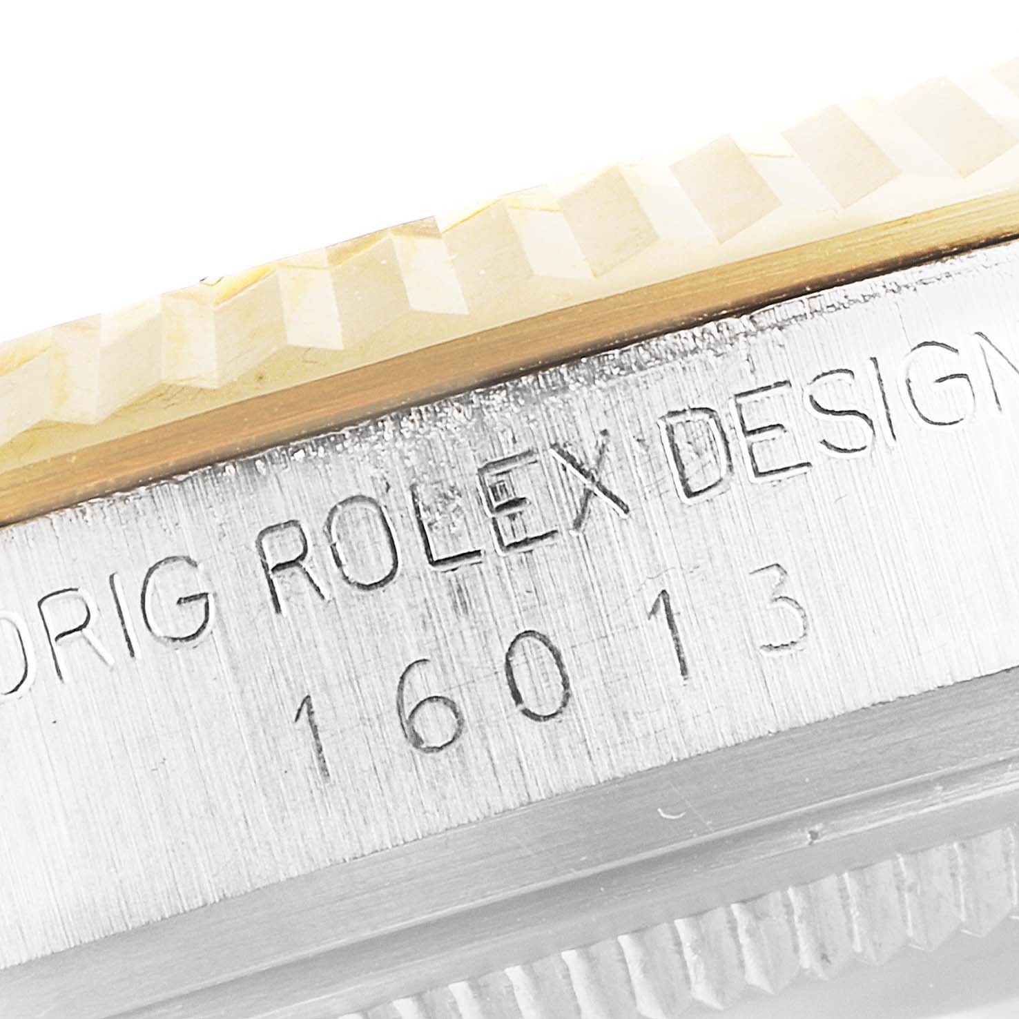 The image shows the side view of the bezel and case of a Rolex Vintage Collection 16013 Men's Steel and Gold (two tone) Champagne Dial 16013 Men's Steel and Gold (two tone) Champagne Dial model, highlighting the engravings.