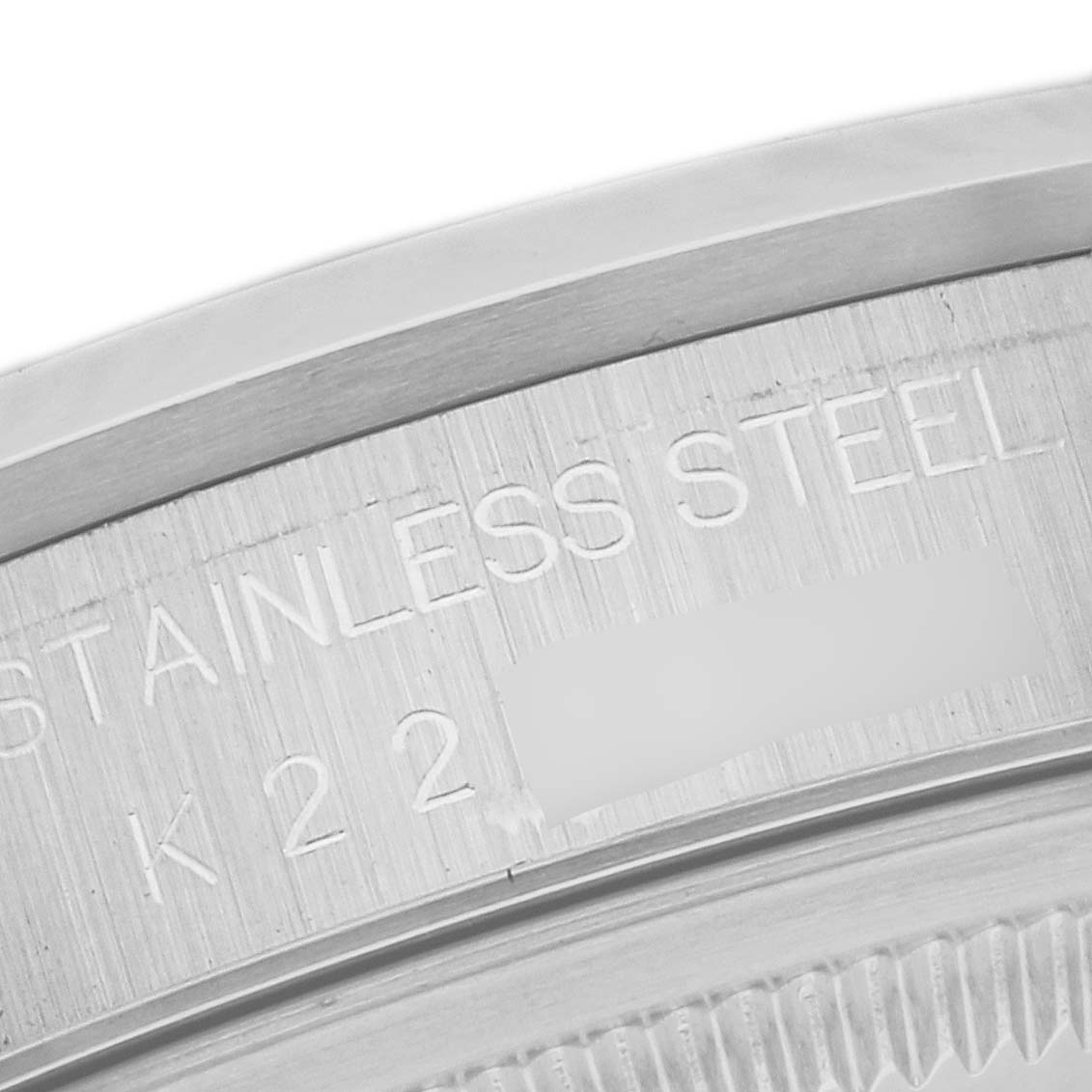 The image shows a close-up of the edge and inscription on the back case of a Rolex Datejust 16200 Men's Stainless Steel Black Dial 16200 Men's Stainless Steel Black Dial model, highlighting the stainless steel material.