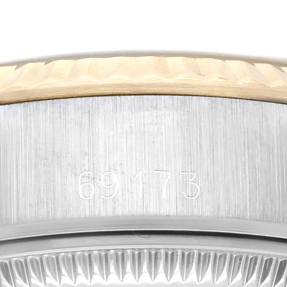 This image shows the model and serial number engraving on the case of a Rolex Datejust 69173G Women's Steel and Gold (two tone) Champagne Dial 69173G Women's Steel and Gold (two tone) Champagne Dial watch, viewed from a close-up angle.