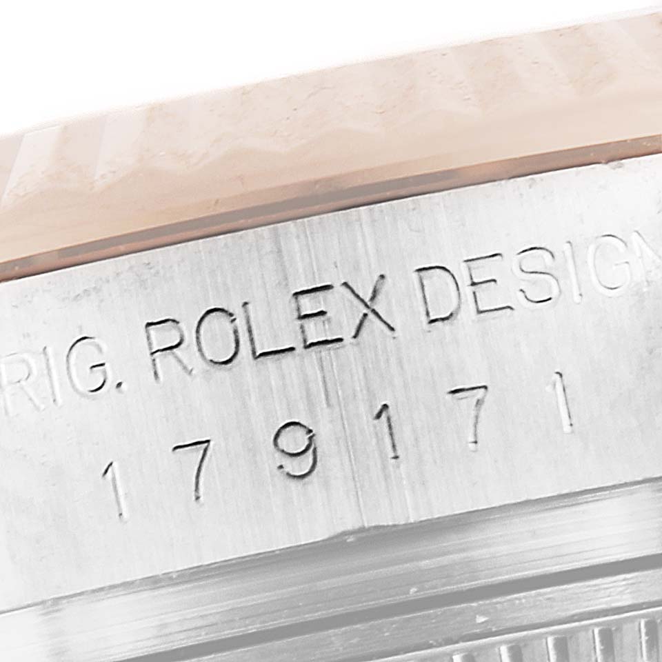 The image shows a close-up of the side engraving and part of the bezel of a Rolex Datejust 179171 Women's Rose Gold Pink Dial 179171 Women's Rose Gold Pink Dial watch.