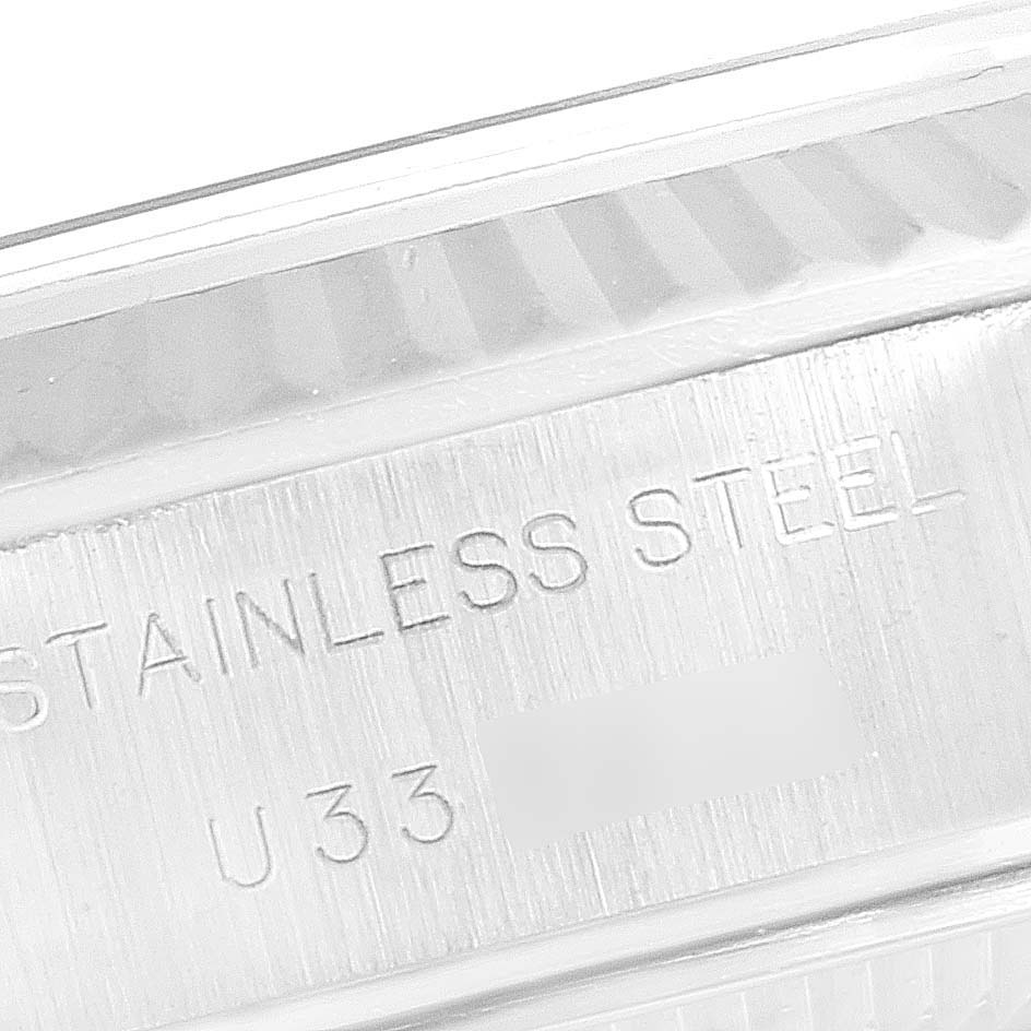 This image shows a close-up of the stainless steel case of a Rolex Datejust 69174 Women's Stainless Steel Pink Dial 69174 Women's Stainless Steel Pink Dial model, focusing on the engraving.