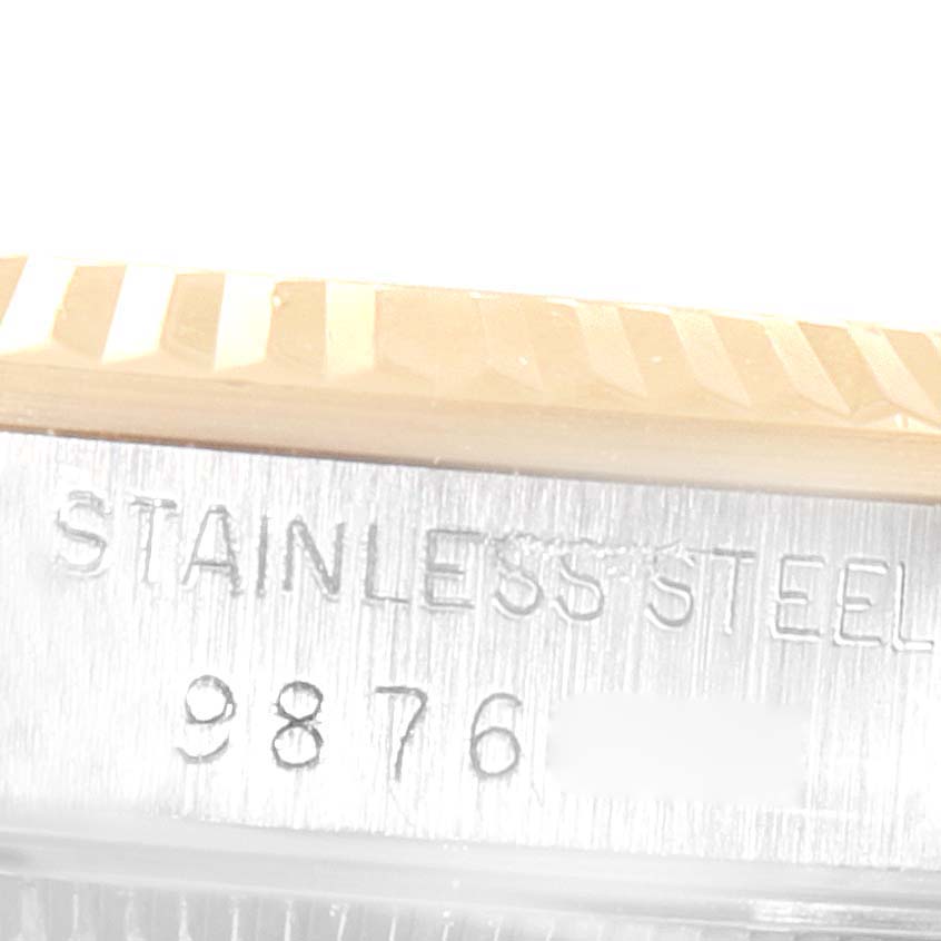 This image shows a close-up of the side of a Rolex Mid-Size 68273 Women
s Steel and Gold (two tone) White Dial 68273 Women
s Steel and Gold (two tone) White Dial watch case, highlighting the bezel and partially visible "STAINLESS STEEL" engraving.