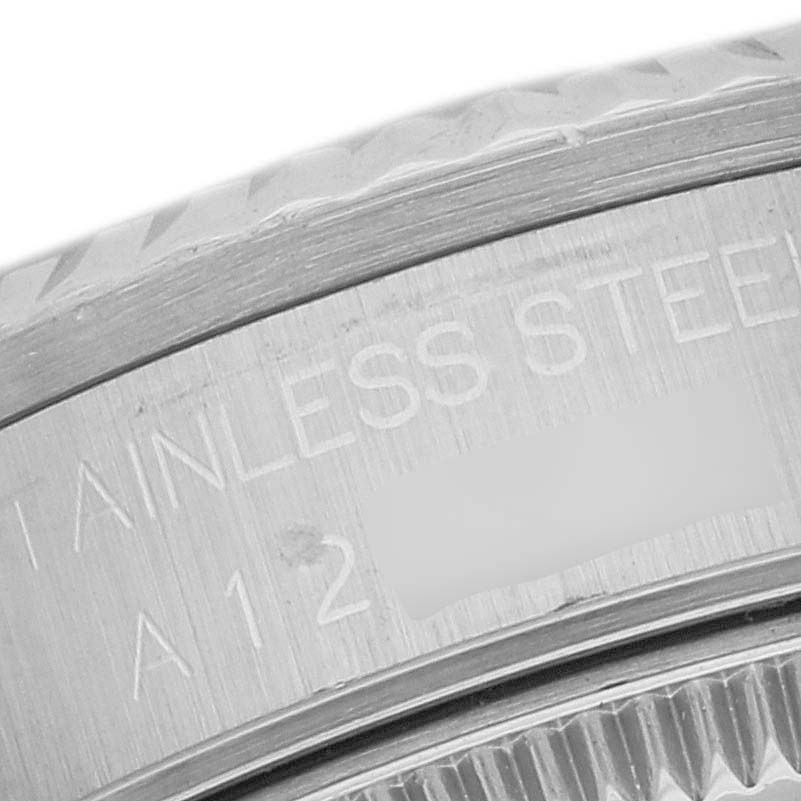 This close-up image shows part of the stainless steel case back with engravings on a Rolex Mid-Size 68274G Women's Stainless Steel Black Dial 68274G Women's Stainless Steel Black Dial watch.