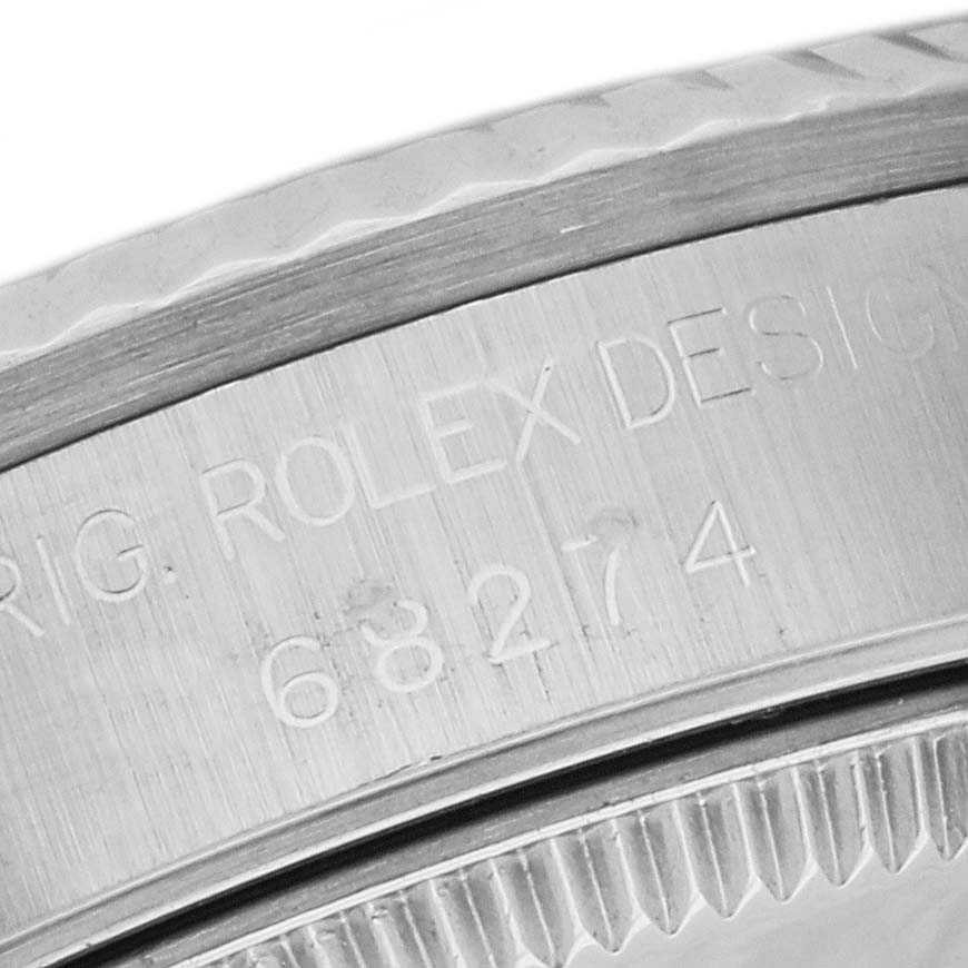 This close-up image shows the engraved side of the bezel and case of a Mid-Size Rolex watch, featuring its model number.