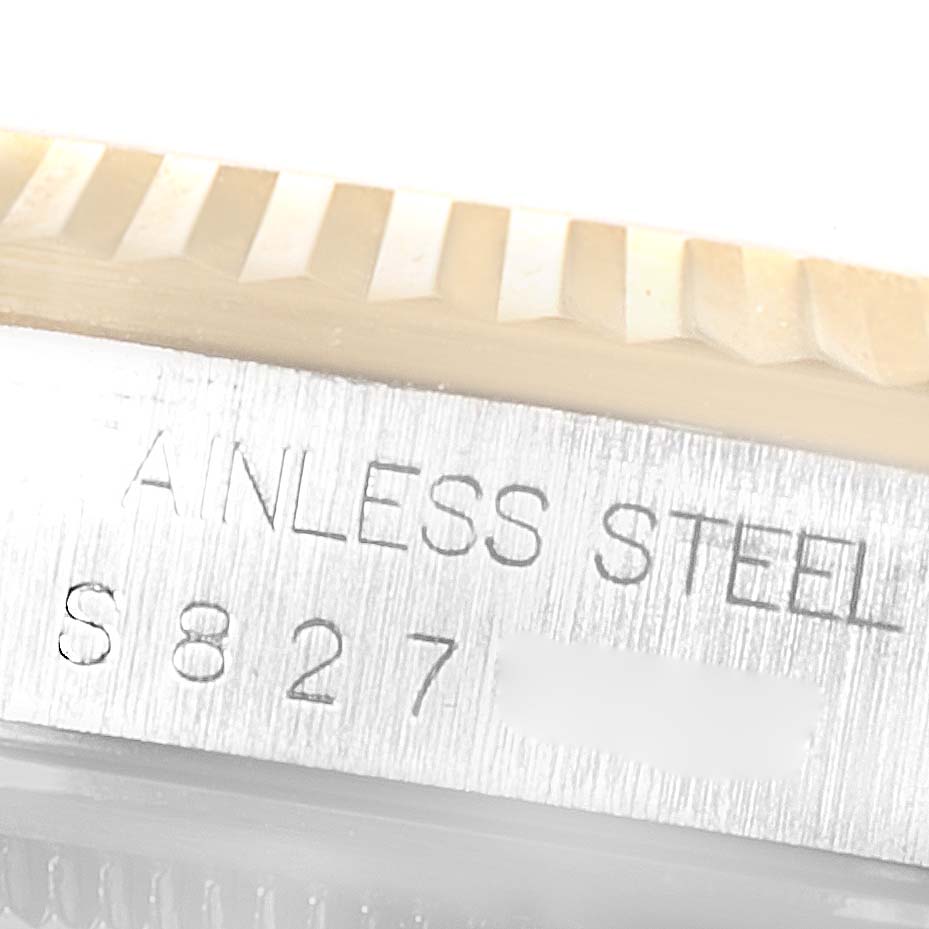 This image shows a close-up of the edge of the bezel and the serial number engraving on a Rolex Datejust 16233 Men's Steel and Gold (two tone) White Dial 16233 Men's Steel and Gold (two tone) White Dial stainless steel watch.