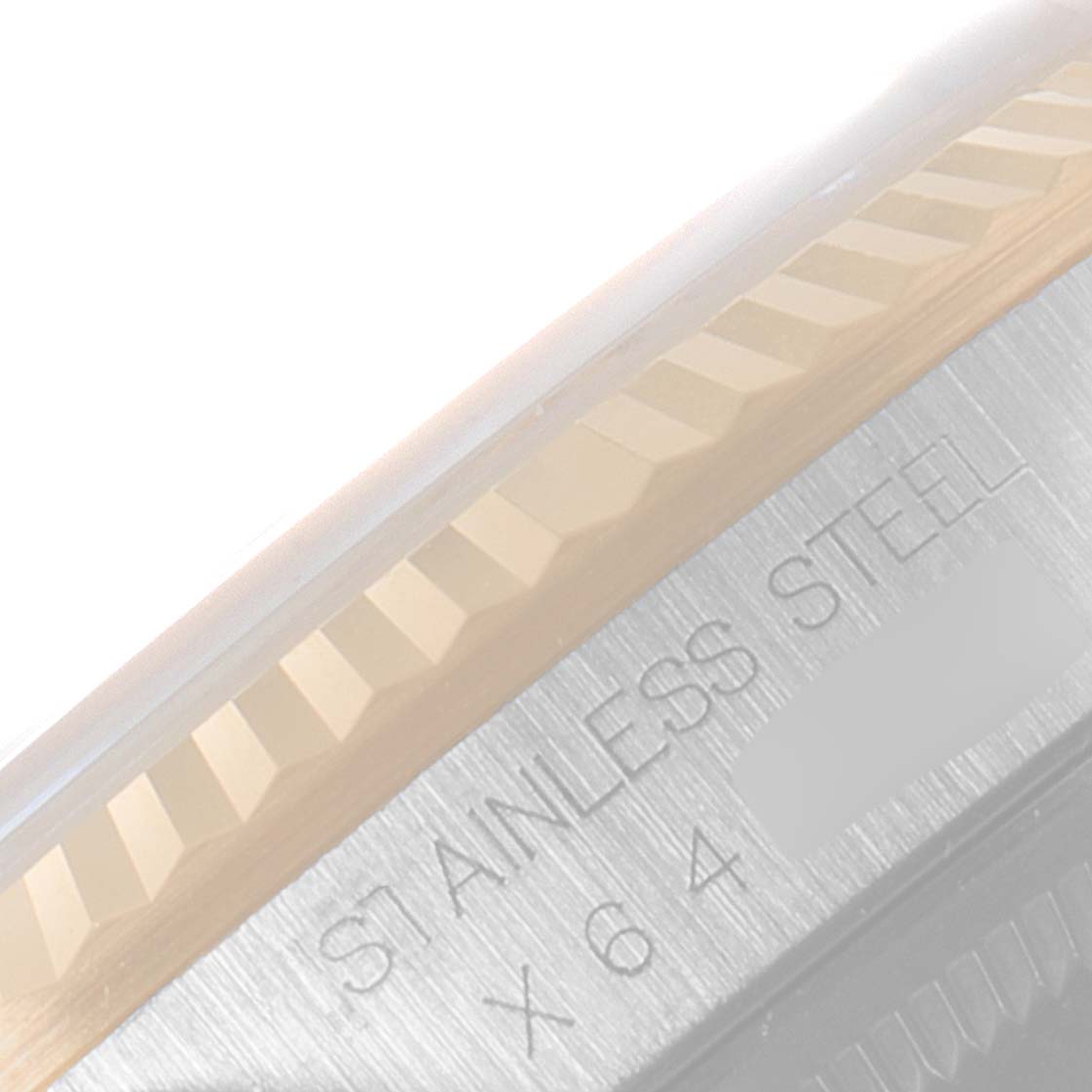 The image shows a close-up angle of the fluted bezel and stainless steel detailing of a Rolex Datejust 16233 Men's Steel and Gold (two tone) Champagne Dial 16233 Men's Steel and Gold (two tone) Champagne Dial watch.