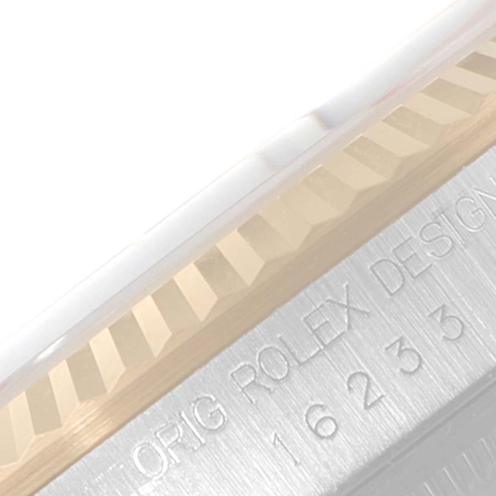 This close-up image shows the fluted bezel and part of the casing of a Rolex Datejust 16233 Men's Steel and Gold (two tone) Champagne Dial 16233 Men's Steel and Gold (two tone) Champagne Dial model watch.