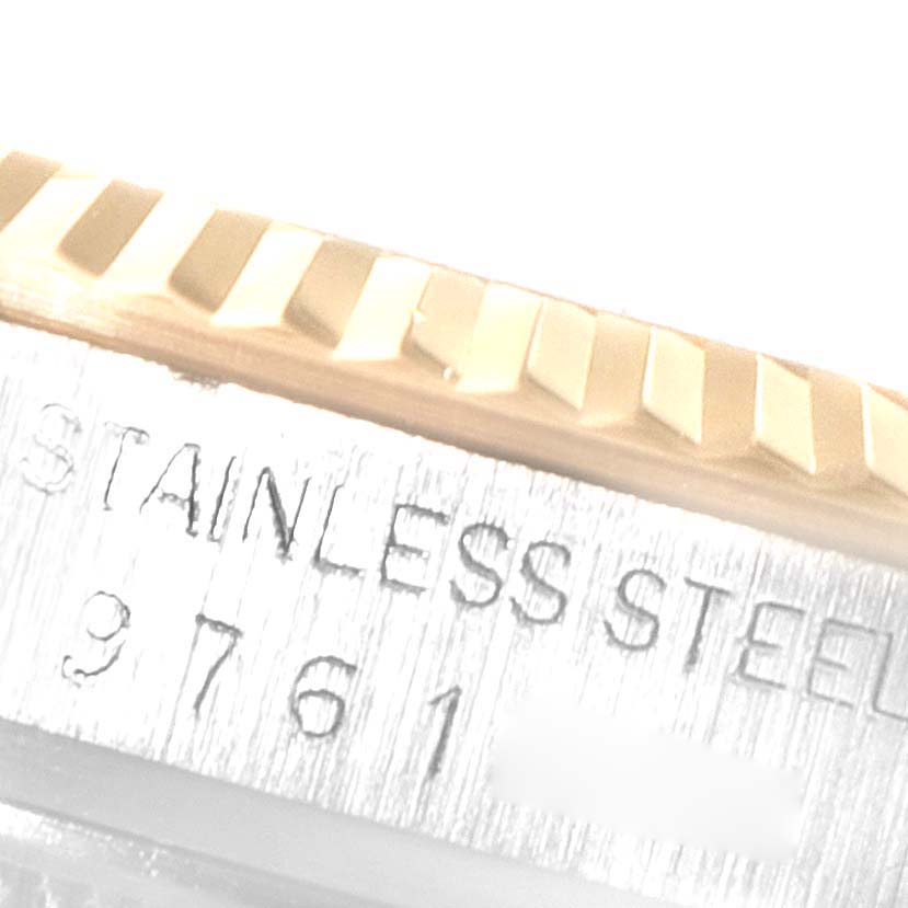 This close-up angle of the Rolex Datejust 16013 Men
s Steel and Gold (two tone) Champagne Dial 16013 Men
s Steel and Gold (two tone) Champagne Dial watch shows a detailed view of the bezel and part of the watch
s case with engraved text.