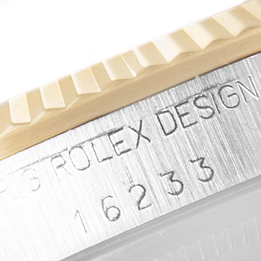 This image shows a close-up of the engraved model number and part of the bezel of a Rolex Datejust 16233 Men's Steel and Gold (two tone) Blue Dial 16233 Men's Steel and Gold (two tone) Blue Dial watch.