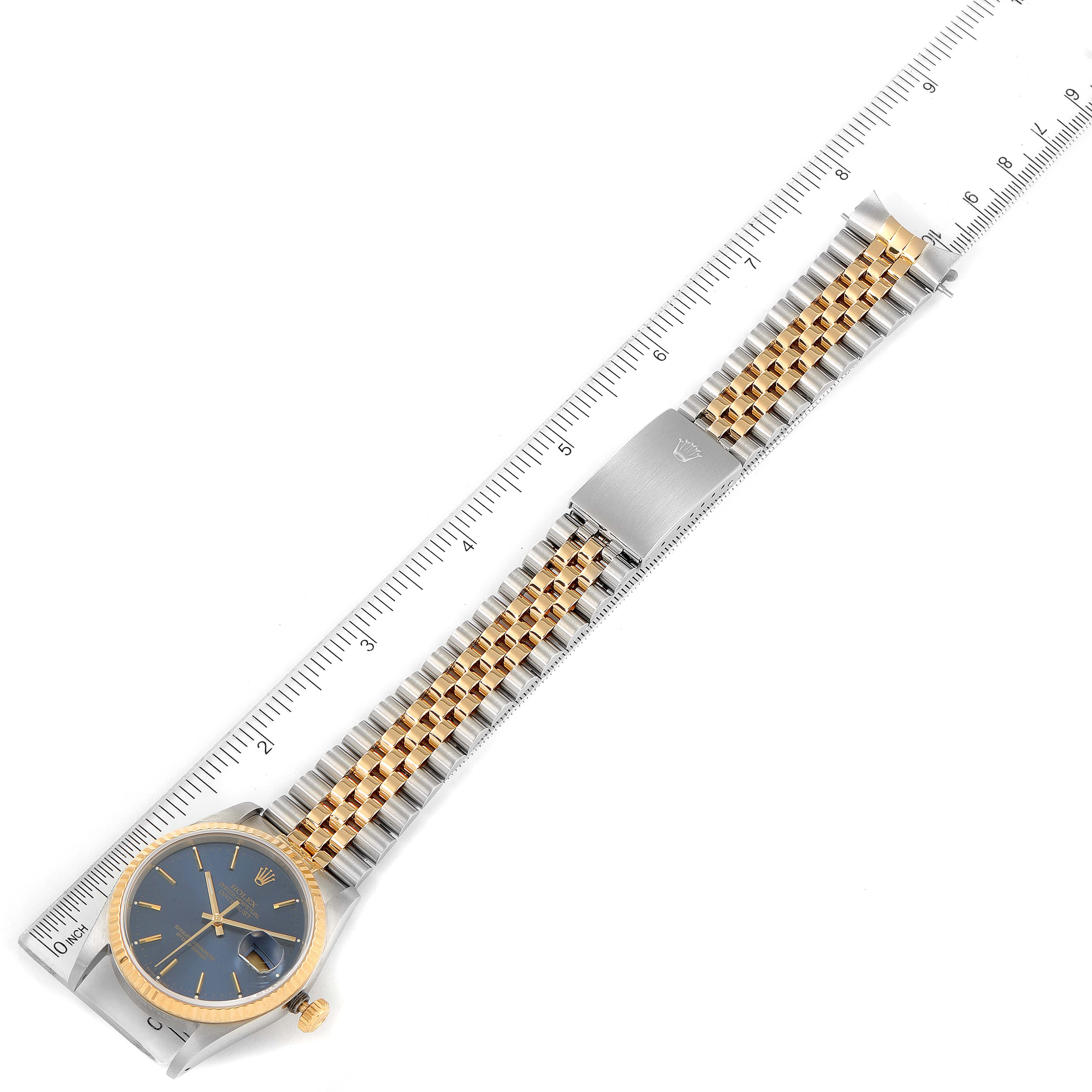 This image shows a Rolex Datejust 16233 Men's Steel and Gold (two tone) Blue Dial 16233 Men's Steel and Gold (two tone) Blue Dial watch at a top-down angle, highlighting the dial, case, and two-tone bracelet with a measurement scale.