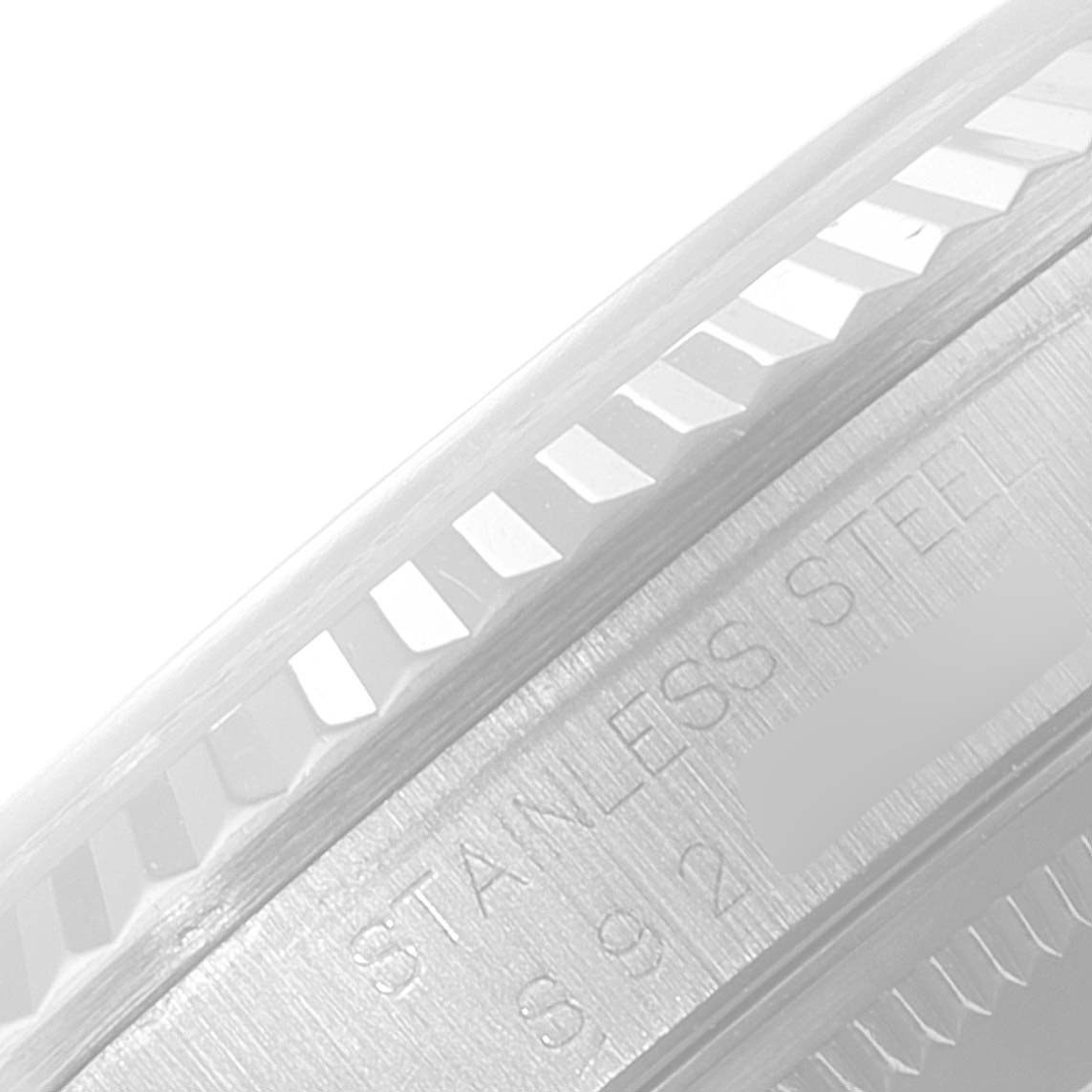 The image shows a close-up of the stainless steel bezel and edge of the case back of a Rolex Datejust 16234 Men's Stainless Steel Silver Dial 16234 Men's Stainless Steel Silver Dial watch.