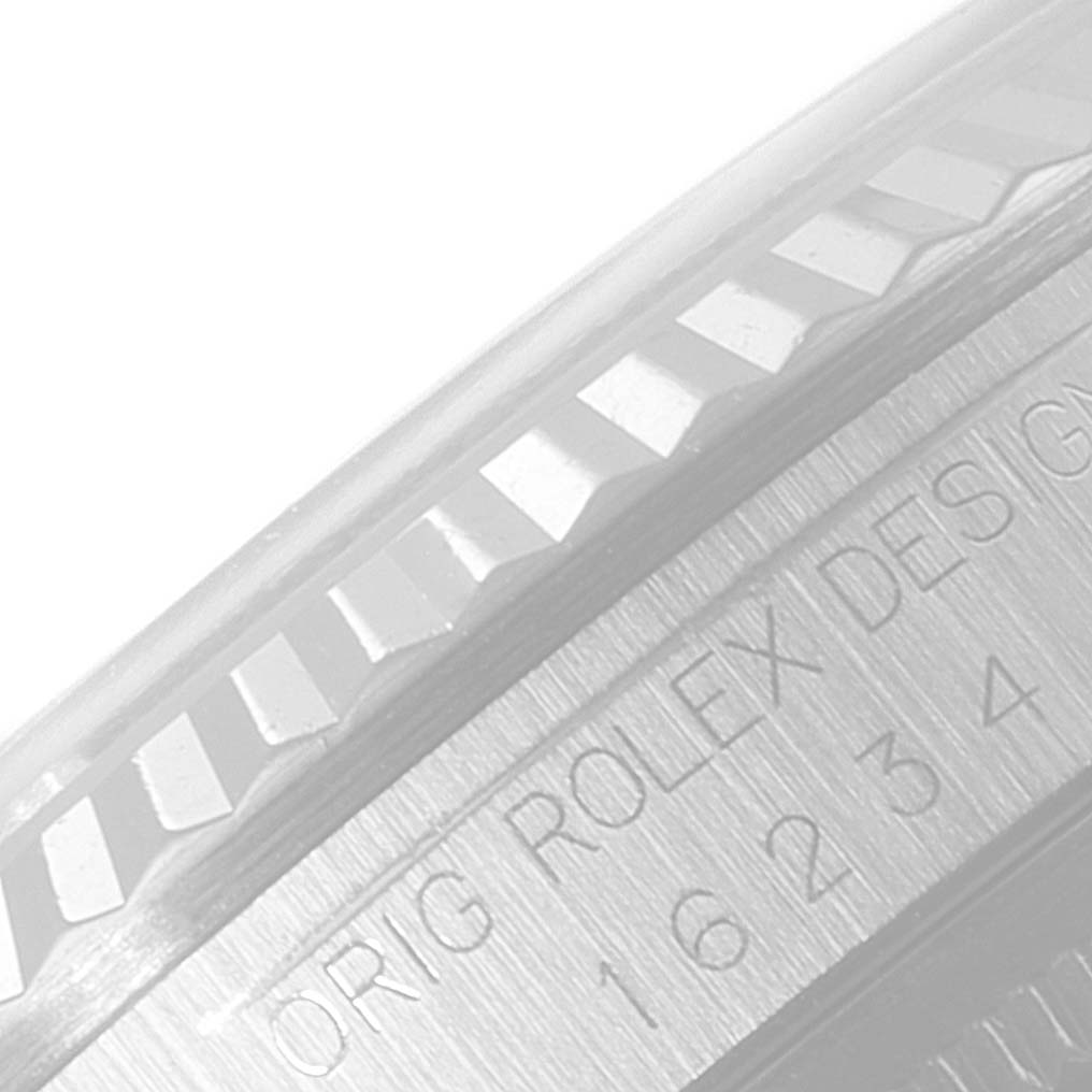 This image shows a close-up of the side of the bezel and case of a Rolex Datejust 16234 Men's Stainless Steel Silver Dial 16234 Men's Stainless Steel Silver Dial watch, highlighting the fluted bezel and engravings.