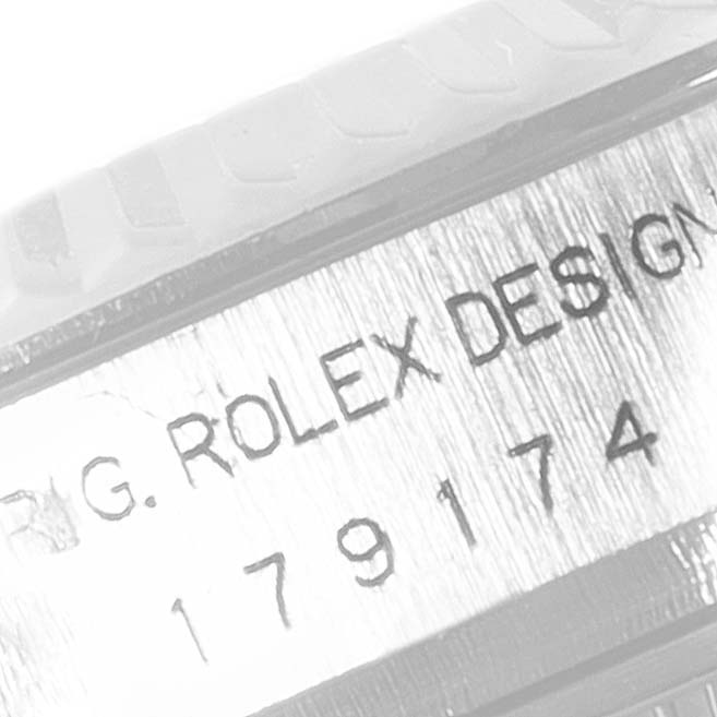 This close-up angle shows the serial number and "ROLEX DESIGN" engraving on the case of a Rolex Datejust 179174 Women's Stainless Steel Black Dial 179174 Women's Stainless Steel Black Dial watch.