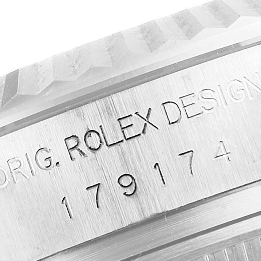 This image shows a close-up of the engraved serial number and part of the bezel of a Rolex Datejust 179174 Women
s Stainless Steel Silver Dial 179174 Women
s Stainless Steel Silver Dial watch.