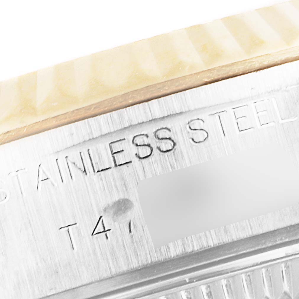 The image shows a close-up of the case side engraving of a Rolex Datejust 69173 Women's Steel and Gold (two tone) Black Dial 69173 Women's Steel and Gold (two tone) Black Dial watch, highlighting "STAINLESS STEEL" and part of the serial number.