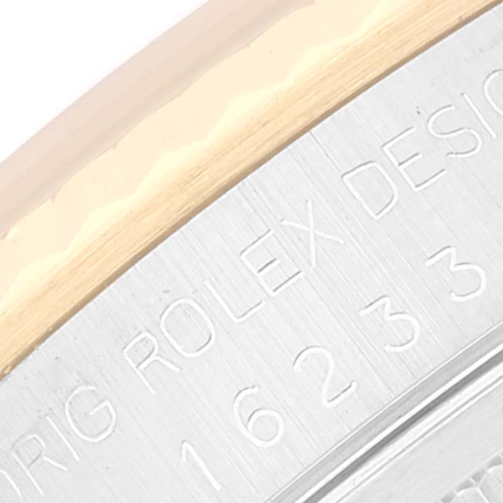 The image shows a close-up detail of the engraving on the case side of a Rolex Datejust 16233 Men's Steel and Gold (two tone) Champagne Dial 16233 Men's Steel and Gold (two tone) Champagne Dial watch.