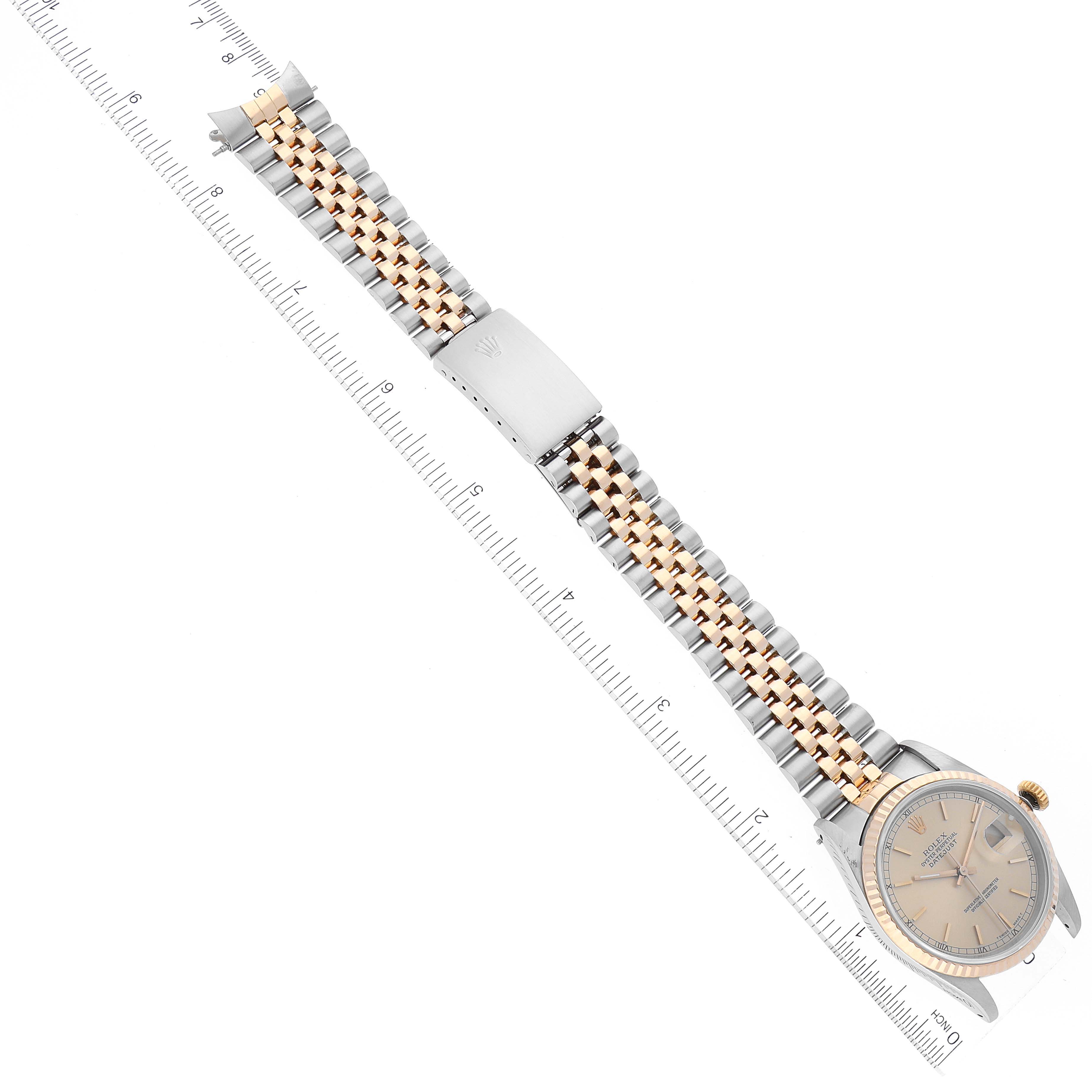 The image shows a Rolex Datejust 16233 Men's Steel and Gold (two tone) Champagne Dial 16233 Men's Steel and Gold (two tone) Champagne Dial watch placed diagonally, displaying its dial, bracelet, and clasp against a ruler for size reference.