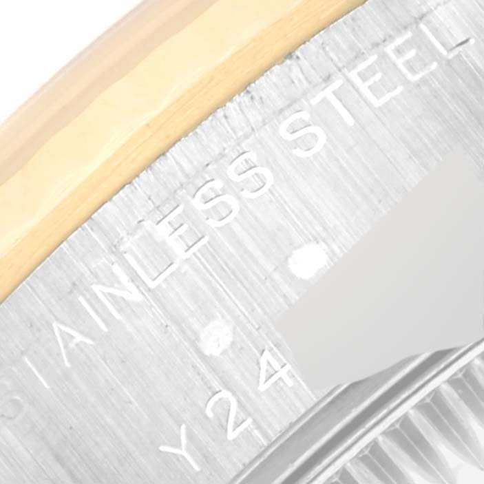This image shows a close-up of the stainless steel and gold bezel and part of the text engraving on a Rolex Datejust 79173G Women's Steel and Gold (two tone) Champagne Dial 79173G Women's Steel and Gold (two tone) Champagne Dial watch.