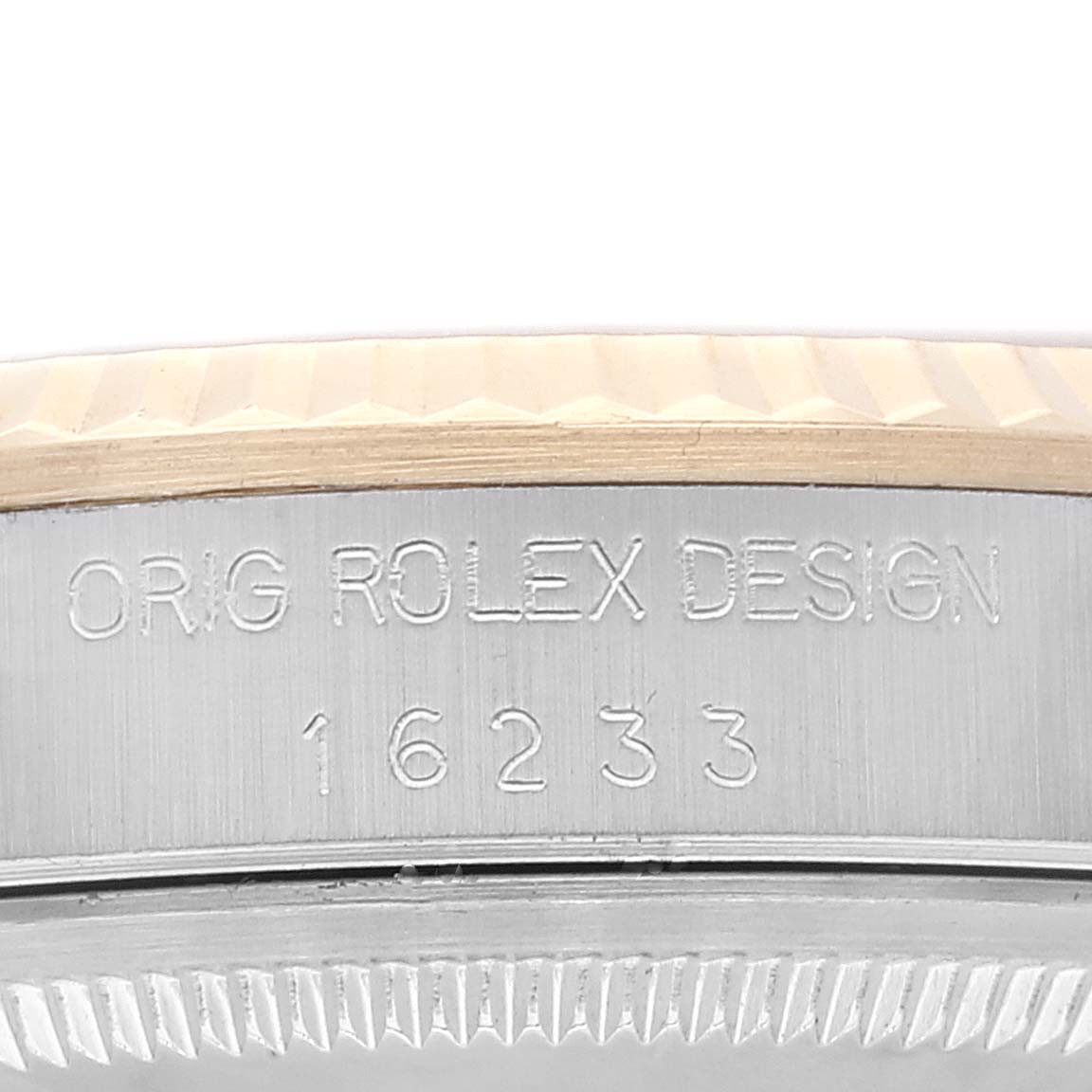The image shows a close-up of the case side of a Rolex Datejust 16233 Men's Steel and Gold (two tone) Champagne Dial 16233 Men's Steel and Gold (two tone) Champagne Dial model, highlighting the engraved model number and design text.