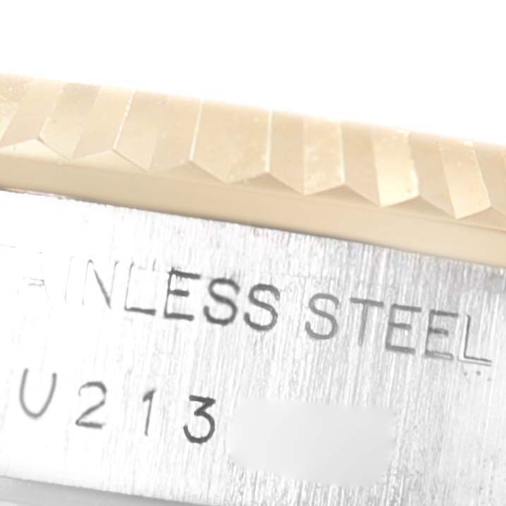 This image shows a close-up of the fluted bezel and stainless steel engraved serial number on a Rolex Datejust 69173 Women
s Stainless Steel White Dial 69173 Women
s Stainless Steel White Dial watch.