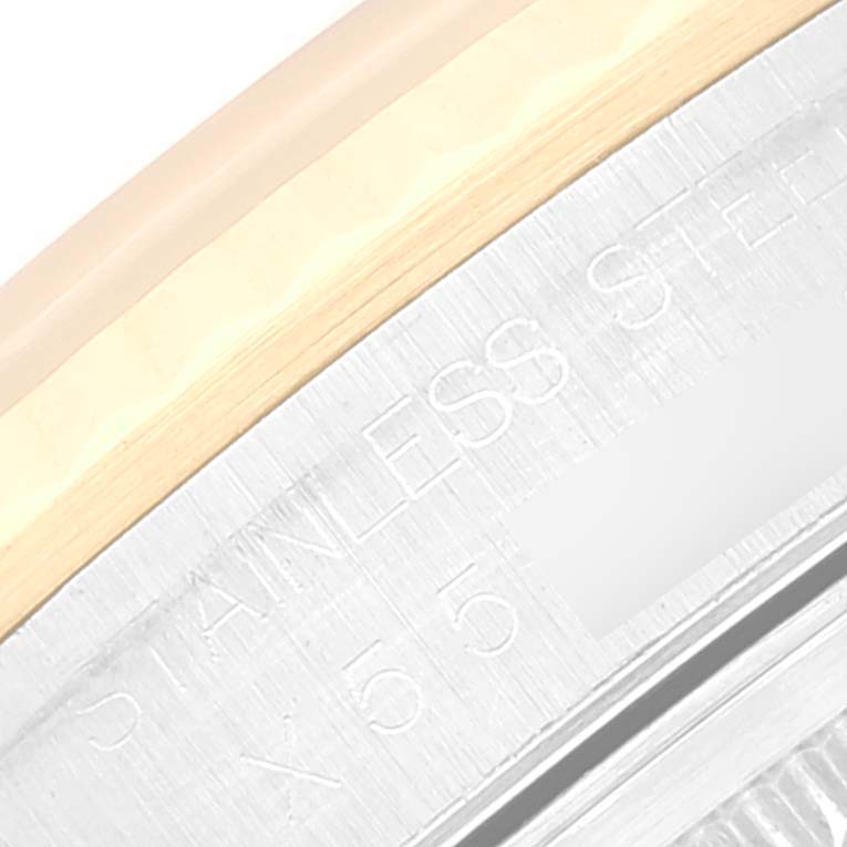 The image shows a close-up view of the stainless steel and gold bezel with engraved text, part of the Rolex Datejust 16233 Men's Steel and Gold (two tone) Silver Dial 16233 Men's Steel and Gold (two tone) Silver Dial model.