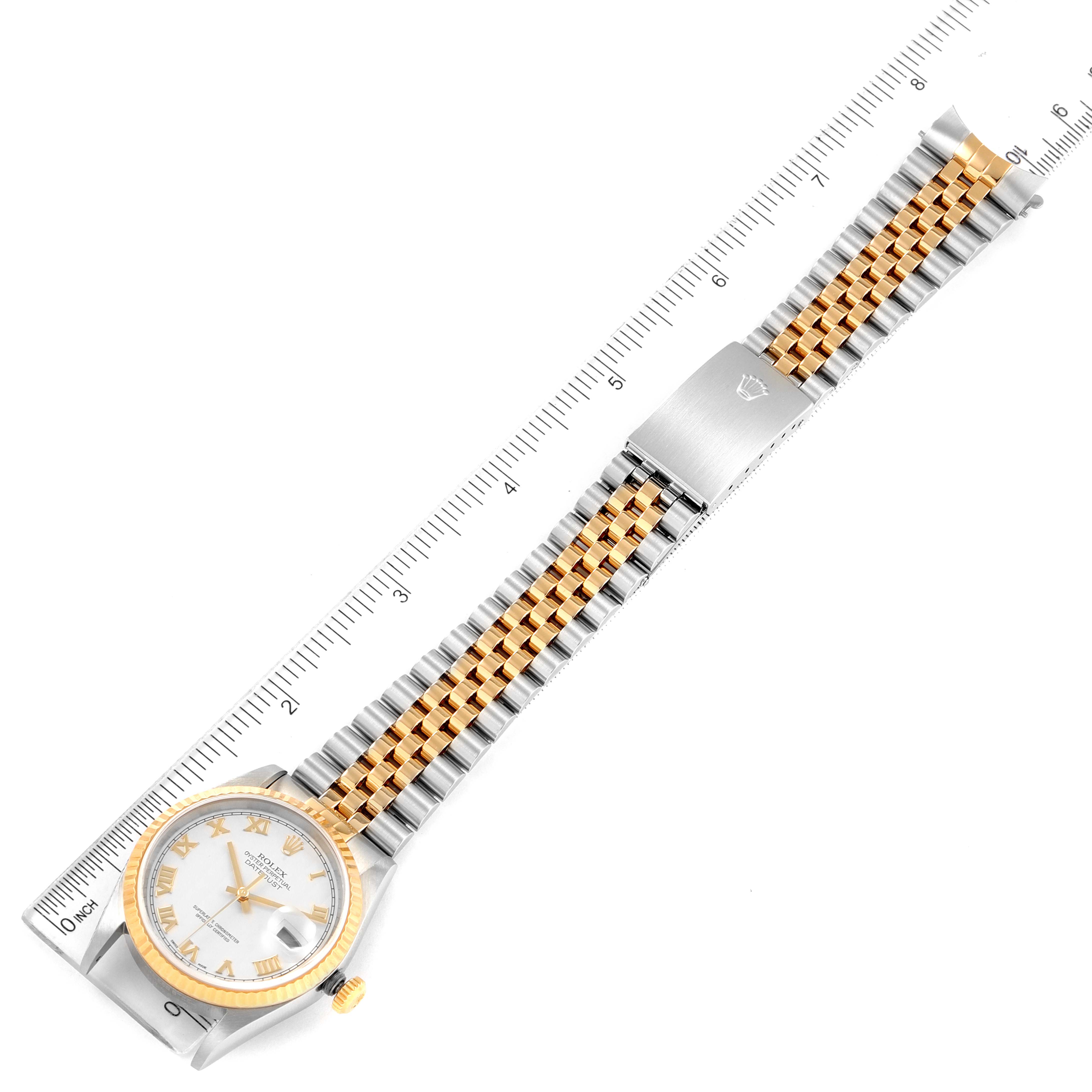 This image shows a top-down view of a Rolex Datejust 16233 Men's Steel and Gold (two tone) Beige Dial 16233 Men's Steel and Gold (two tone) Beige Dial watch, showcasing the dial, bezel, and full bracelet next to a ruler.