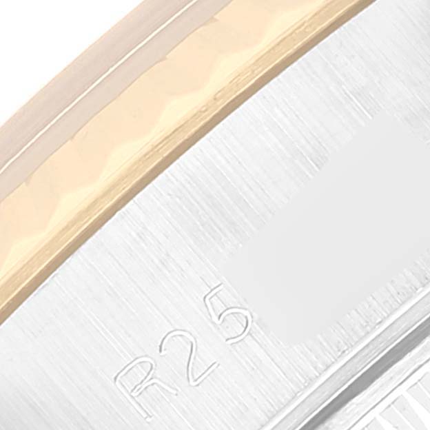 This image shows a close-up of the metal edge and engraved code of the Rolex Datejust 69173 Women's Steel and Gold (two tone) Silver Dial 69173 Women's Steel and Gold (two tone) Silver Dial watch.