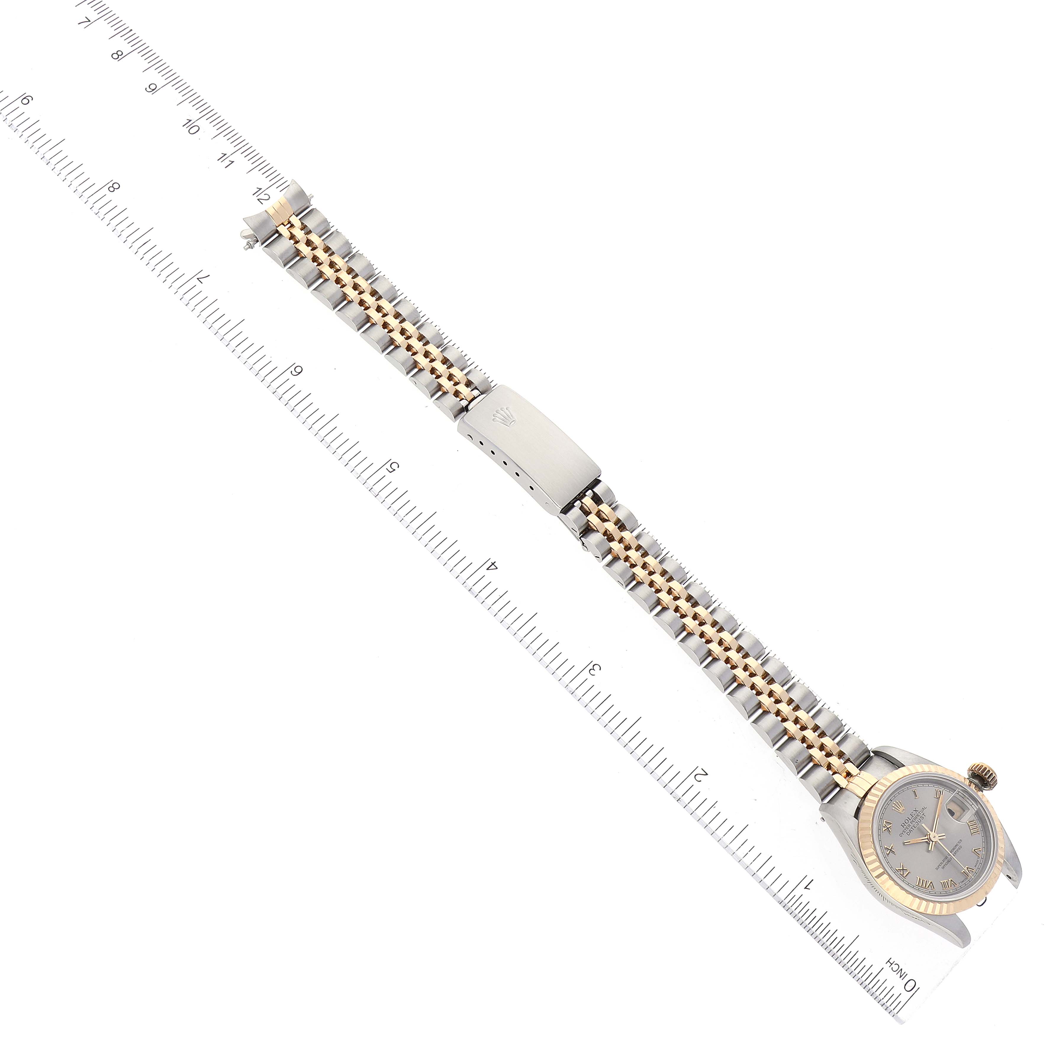 The image shows a top-down view of a Rolex Datejust 69173 Women's Steel and Gold (two tone) Grey Dial 69173 Women's Steel and Gold (two tone) Grey Dial watch, including the dial, bracelet, and clasp beside a ruler for scale.