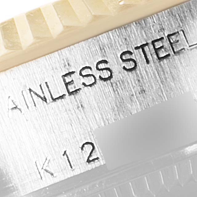 The image shows a close-up of the steel bezel and part of the engraved text on a Rolex Datejust 79173 Women's Steel and Gold (two tone) White Dial 79173 Women's Steel and Gold (two tone) White Dial watch.