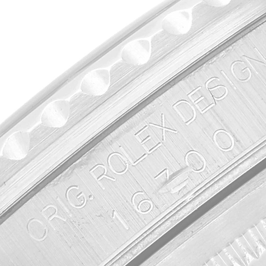 This close-up shows the side of the case with the engraving "ORIG. ROLEX DESIGN 16700" on the Rolex GMT-Master 16700 Men
s Stainless Steel Black Dial 16700 Men
s Stainless Steel Black Dial watch.