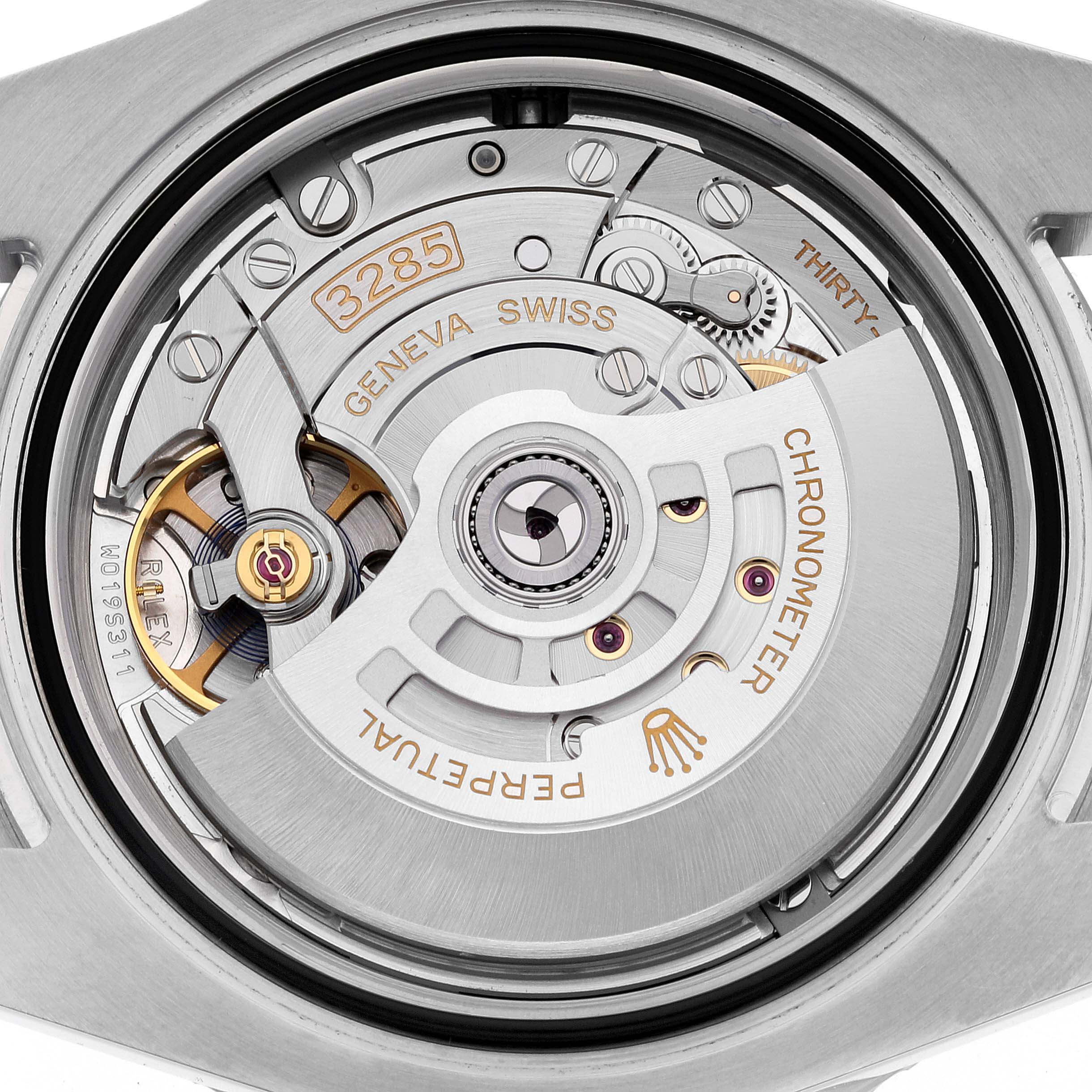 This image shows a close-up of the Rolex GMT-Master 126710BLRO Men
s Stainless Steel Black Dial 126710BLRO Men
s Stainless Steel Black Dial’s 3285 movement from the back, highlighting various components and engravings.